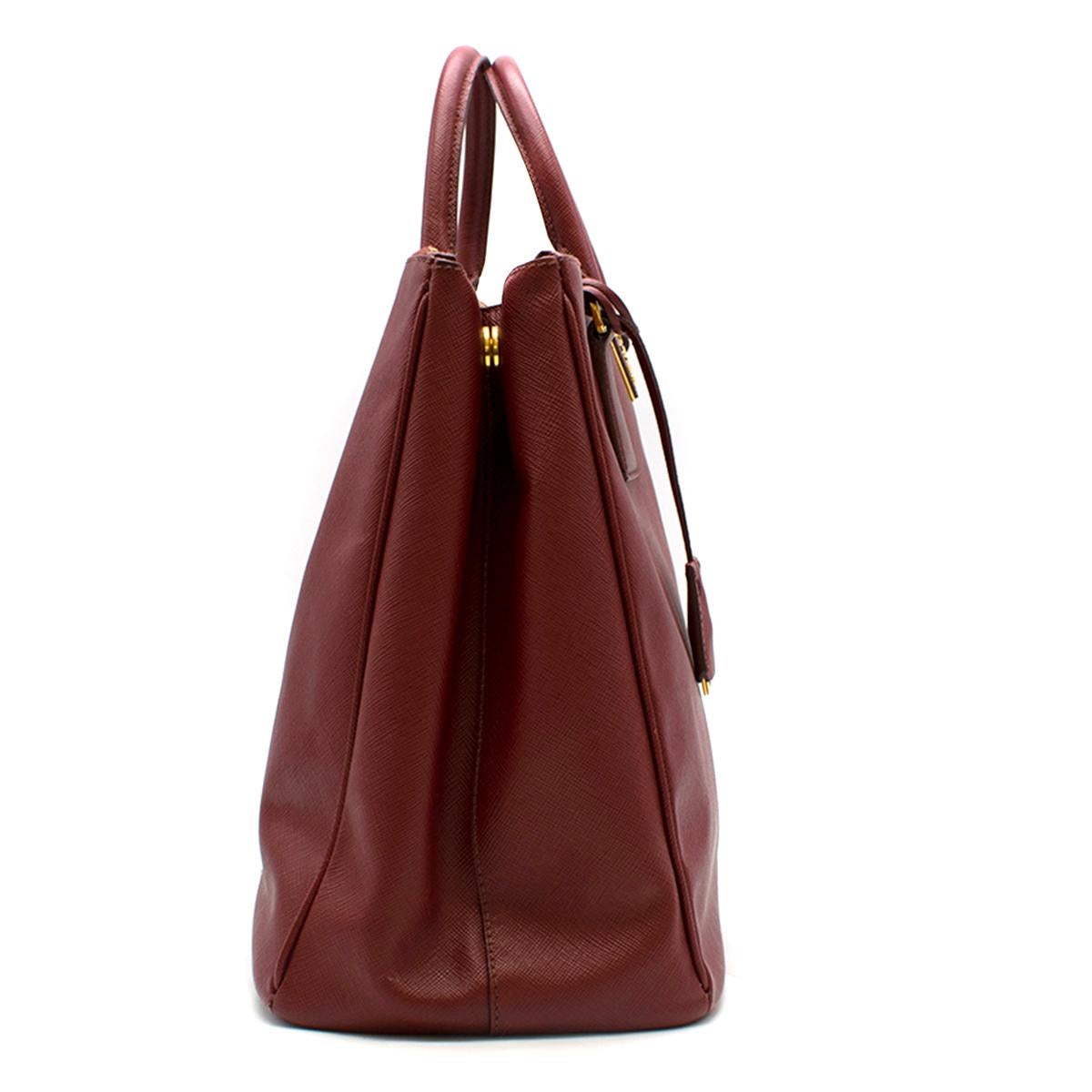 Prada Red Leather Galleria Saffiano Top-handle Bag 

- Red, leather top-handle bag
- Gold tone hardware
- Double zip fastening closure
- Interior zip pocket
- Two interior compartments
- Tubular handles
- Signature logo at the front
- Square