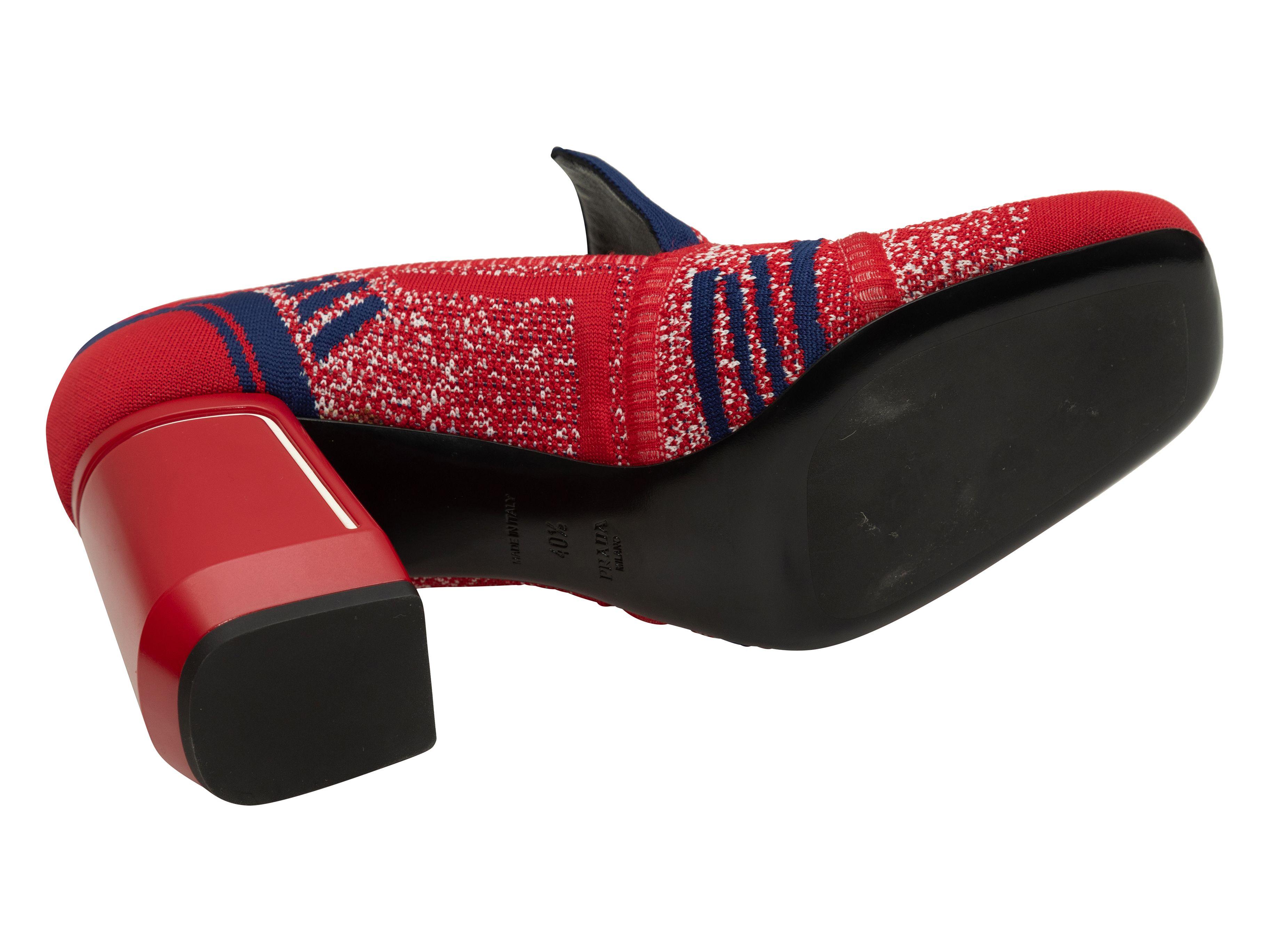 Product Details: Red and navy knit heeled loafers by Prada. Block heels. 3.75