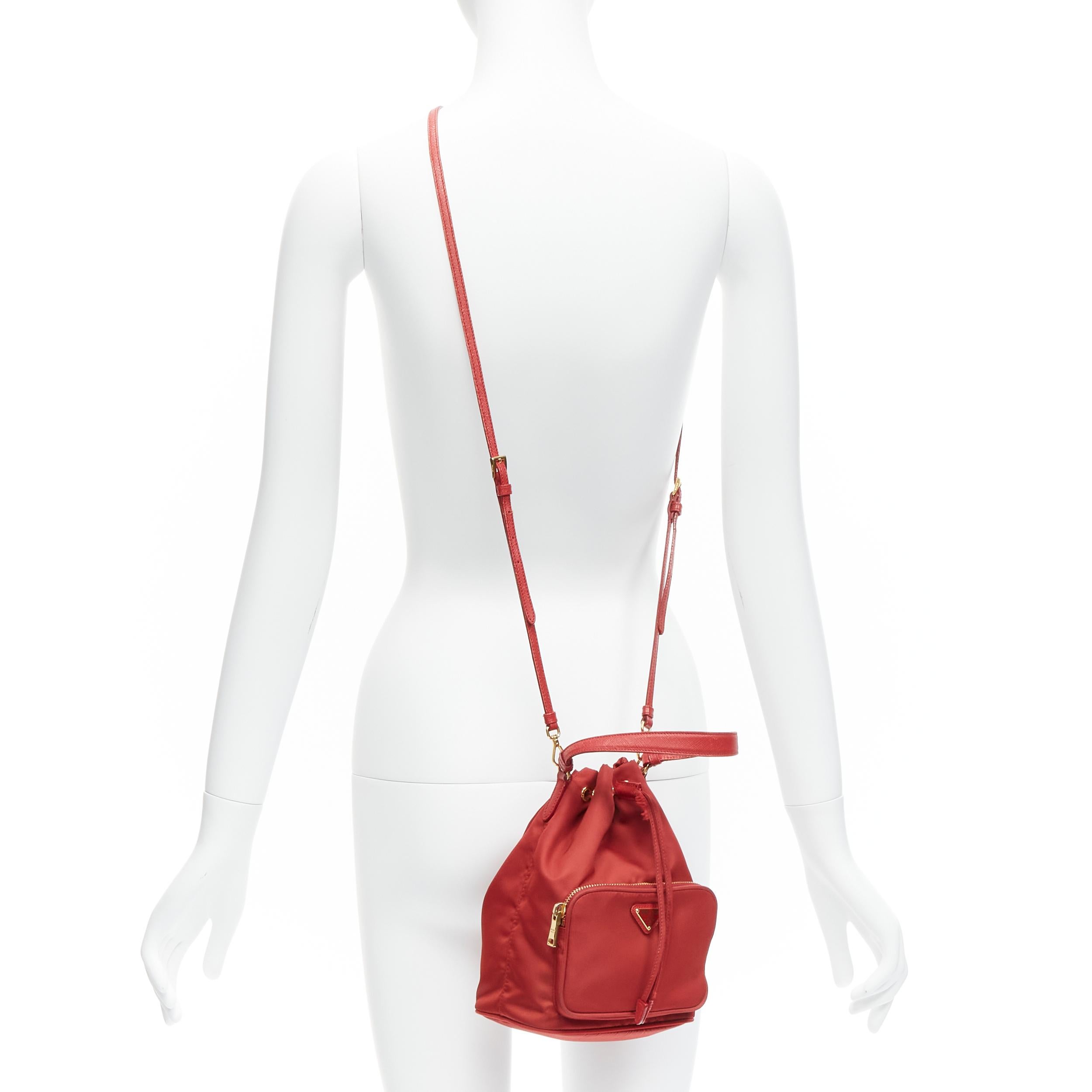 PRADA red nylon gold triangle plate drawstring bucket crossbody shoulder bag
Reference: TGAS/D00083
Brand: Prada
Designer: Miuccia Prada
Material: Nylon, Leather
Color: Red, Gold
Pattern: Solid
Closure: Drawstring
Lining: Red Fabric
Extra Details: