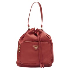 PRADA red nylon gold triangle plate drawstring bucket crossbody shoulder bag