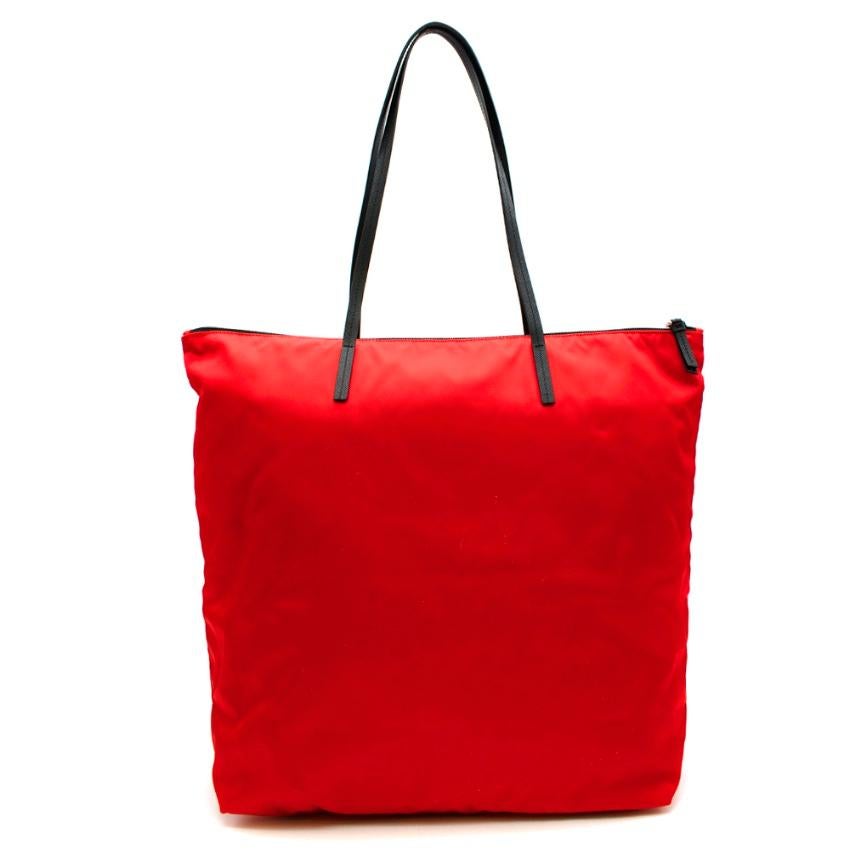 Prada Red Nylon & Saffiano Leather Tote Bag

-Made of Pradas now iconic nylon 
-Luxurious signature saffiano leather shoulder straps and details 
-Prada triangular logo hardware to the front 
-Zip fastening to the top
-Zipped interior pocket