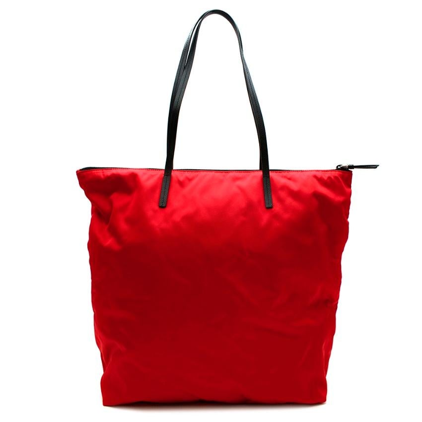 Prada Red Nylon & Saffiano Leather Tote Bag

- Iconic style 
- Made of Prada's now iconic nylon 
- Luxurious signature saffiano leather shoulder straps and details 
- Prada triangular logo hardware to the front 
- Zip fastening to the top
- Zipped