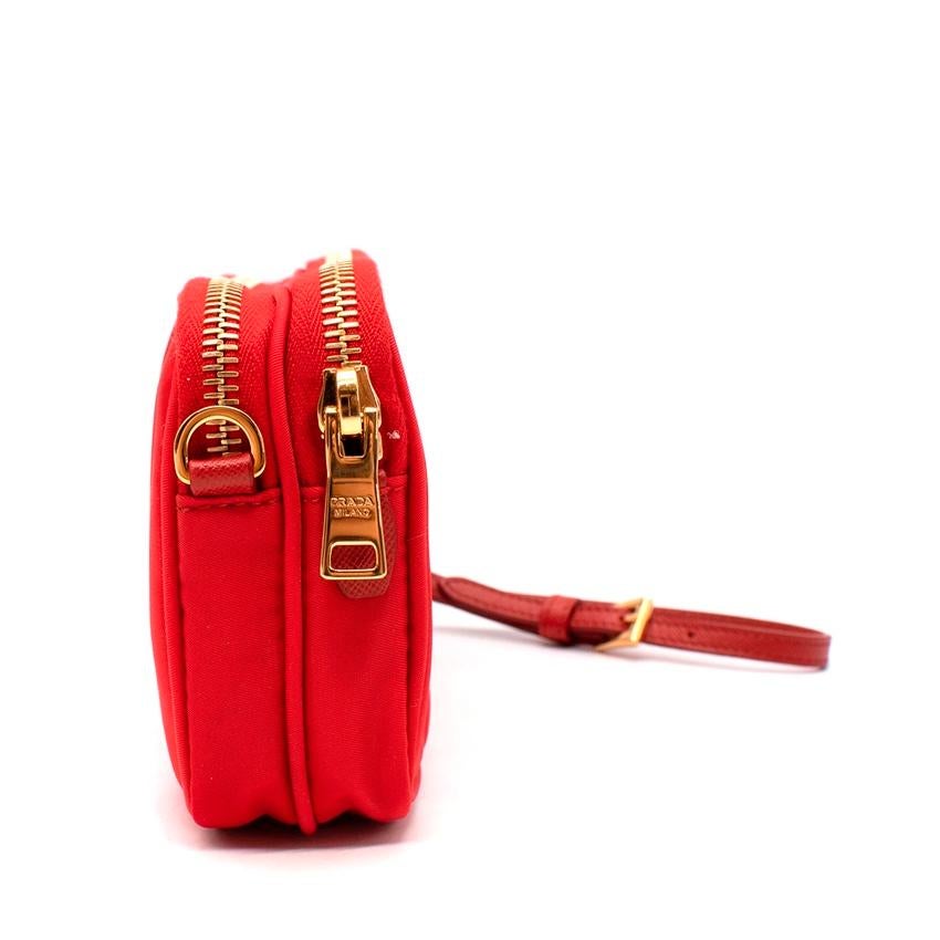  Gucci Red Nylon Pouch Crossbody Bag 
 

 -A round-edged red Prada pouch decorated with the Prada logo on the front.
 -The double gold tone metal zipper pull opens to two main compartment and pocket accented with chic logo lining and there is a