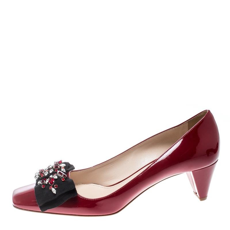 How gorgeous are these pumps from Prada! Ravishing in red, they are crafted from patent leather and feature square toes with crystal embellished bows. Comfortable leather lined insoles and 6.5 cm heels complete this stunning pair.

Includes: