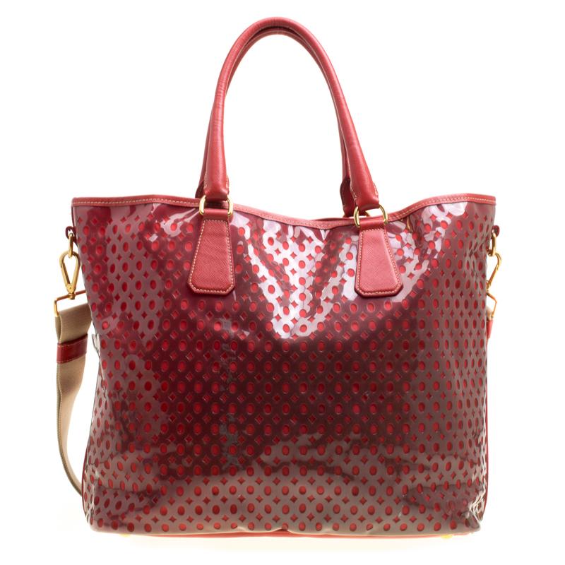 You know what would be the perfect tote to swing for your daily errands or sprees? This one here from Prada. It is perfect! Crafted from perforated PVC, the red bag has a lovely shape, two leather handles, a shoulder strap and a spacious nylon