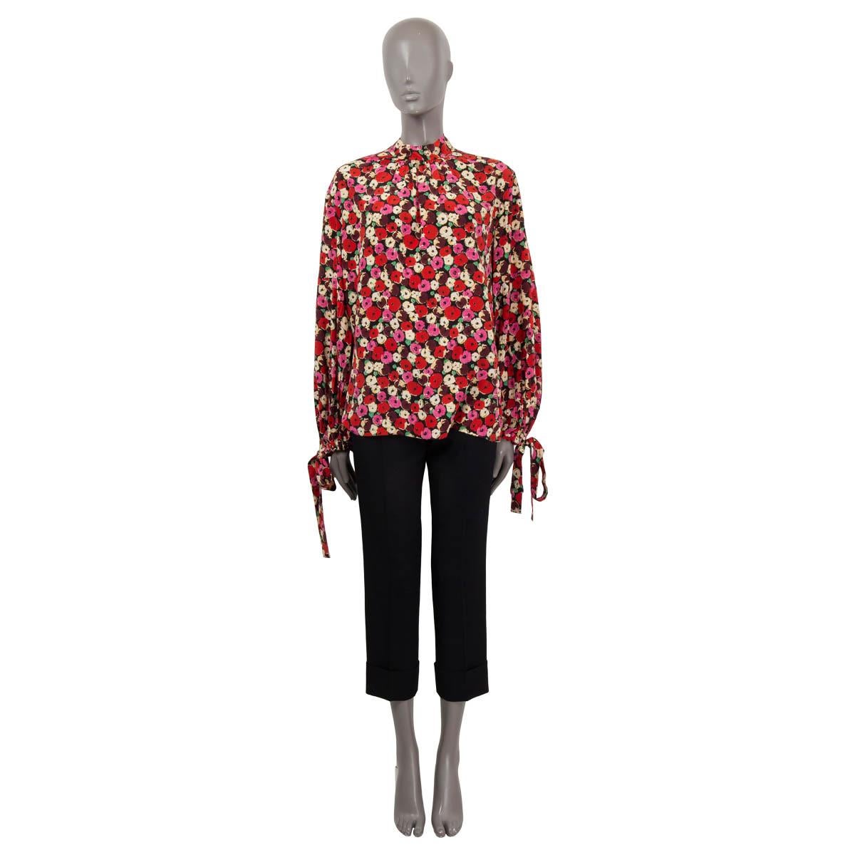 100% authentic Prada floral-print blouse in silk (100%) black, red, pink, purple and yellow. Features a loose fit silhouette and a V-neck in the back. Has a self-tie pussy-bow that can be worn undone, knotted or draped in the back. Has been worn and