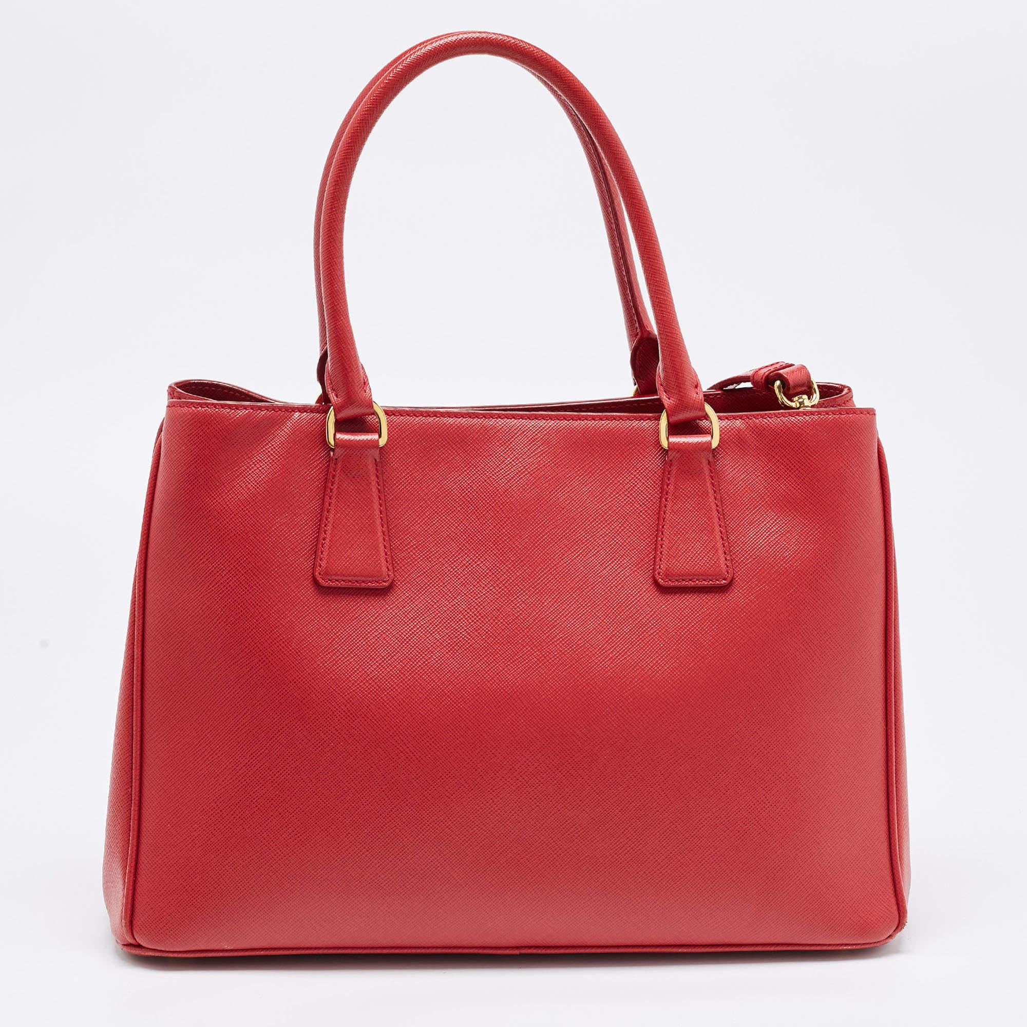 Indulge in luxury with this Prada red bag. Meticulously crafted from premium materials, it combines exquisite design, impeccable craftsmanship, and timeless elegance. Elevate your style with this fashion accessory.

