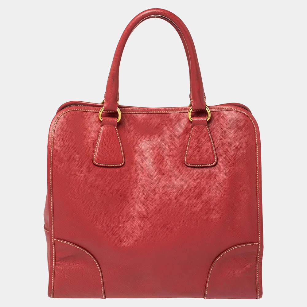 Meticulously created, this tote by Prada is a style statement in itself. Designed from Saffiano Lux leather into a sturdy shape, it exudes style and class in equal measures. This delightful red-hued piece is held by two top handles and equipped with