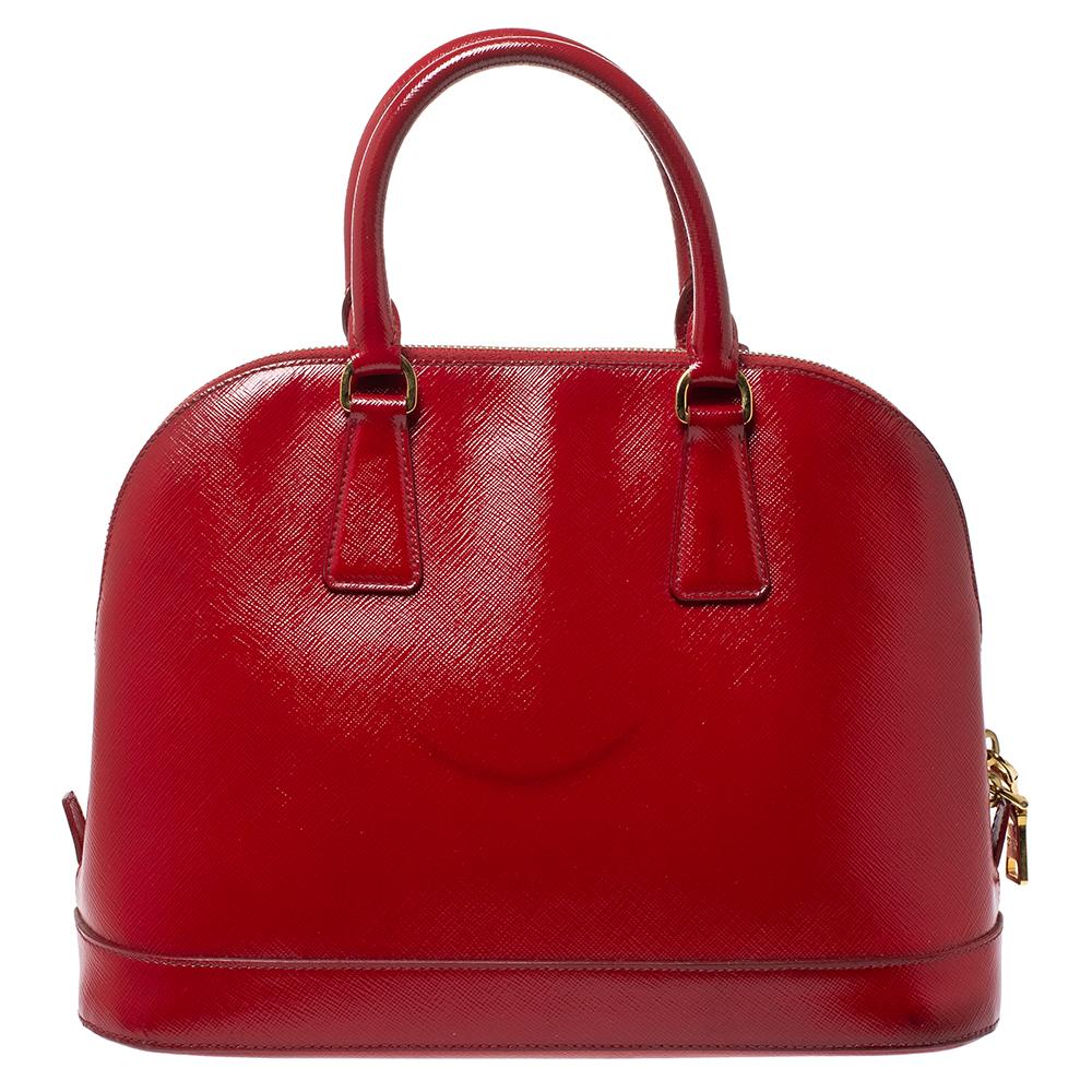 This stunning Promenade tote is high on appeal and style. Dazzling in a classy red shade, the bag is crafted from patent leather and features two rolled handles. The zip closure leads way to a leather interior with enough space for your essentials