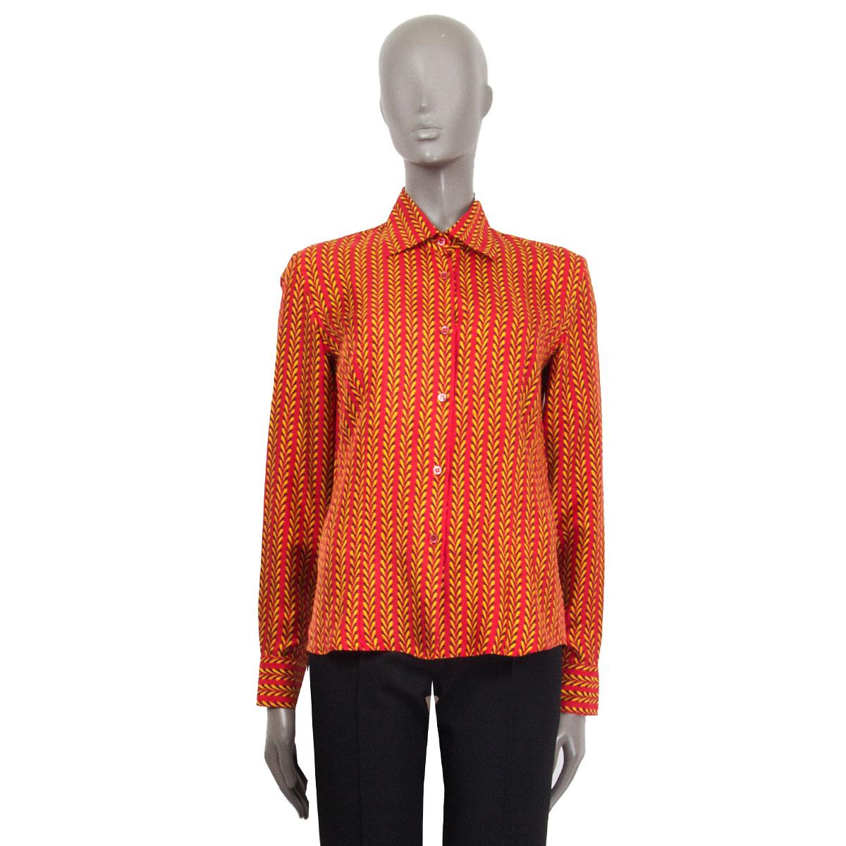 100% authentic Prada 'Holliday & Brown London' re-edited printed shirt in red, yellow and dark brown silk (100%). Has been worn and is in excellent condition. 

Tag Size 40
Size S
Shoulder Width 43cm (16.8in)
Bust 94cm (36.7in)
Waist 87cm