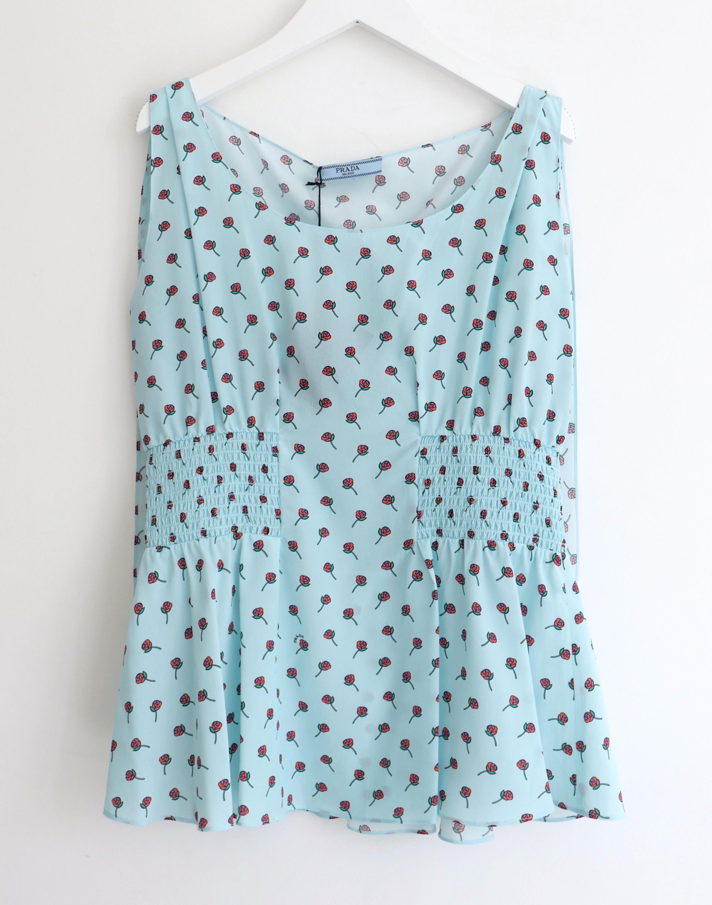Absolutely gorgeous Prada rose print blouse from the Resort 2017 collection. New with tags. Made from beautifully soft aqua blue silk creep with a delicate stylised rose print, it has a super feminine cut with soft fit through the bust, stretchy