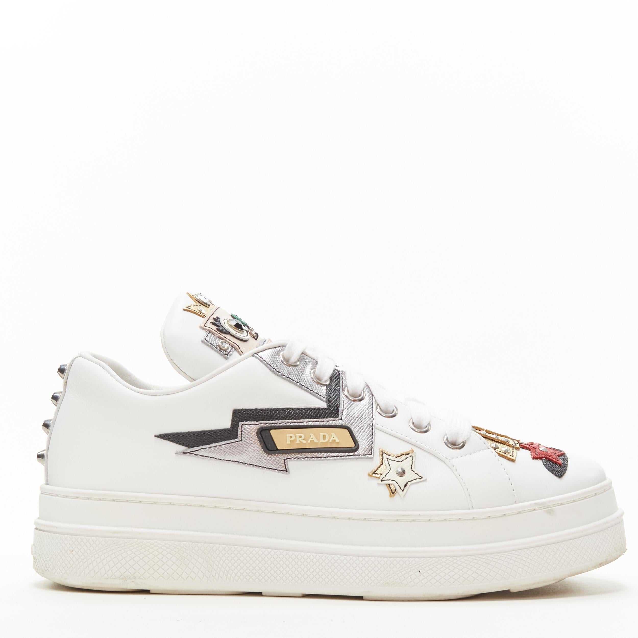 PRADA Robot Queen patchwork embellished white platform sneaker EU36 
Reference: ANWU/A00366 
Brand: Prada 
Designer: Miuccia Prada 
Collection: Robot 
Material: Leather 
Color: White 
Pattern: Solid 
Closure: Lace 
Extra Detail: Robot wear crown