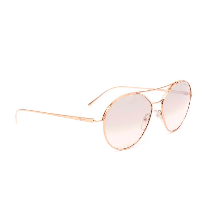 Prada Rose Gold Aviator Sunglasses
 

 - Aviator style sunglasses, with a rose gold tone frame
 - Tonal lenses
 - Logo to the temples
 - Double bridge of contrasting widths
 

 Materials:
 Stainless steel
 

 Made in Italy
 

 PLEASE NOTE, THESE