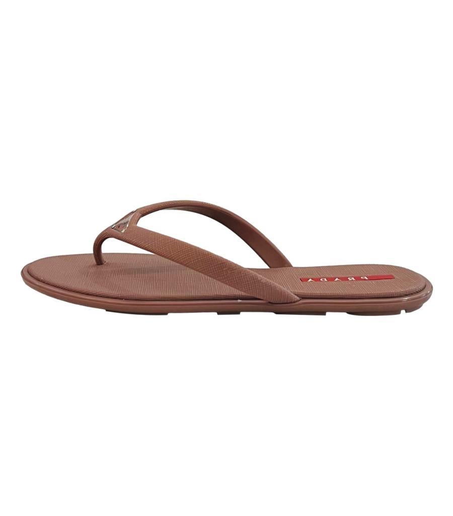 Prada Rubber Logo Flip Flop Sandals
Dusty pink/nude sandals designed with tonal thong straps.
Detailed with signature triangle logo to the vamp.
Size – 35
Condition – Very Good (Some signs of wear and scratches to the logo triangle)
Composition –