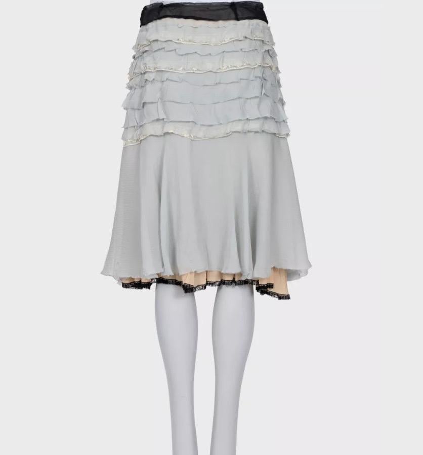This elegant Prada skirt features delicate ruffled detailing and a removable crystal brooch accent. The refined, fitted silhouette embodies the brand’s timeless Italian craftsmanship and modern sophistication. Perfect for creating an elegant and