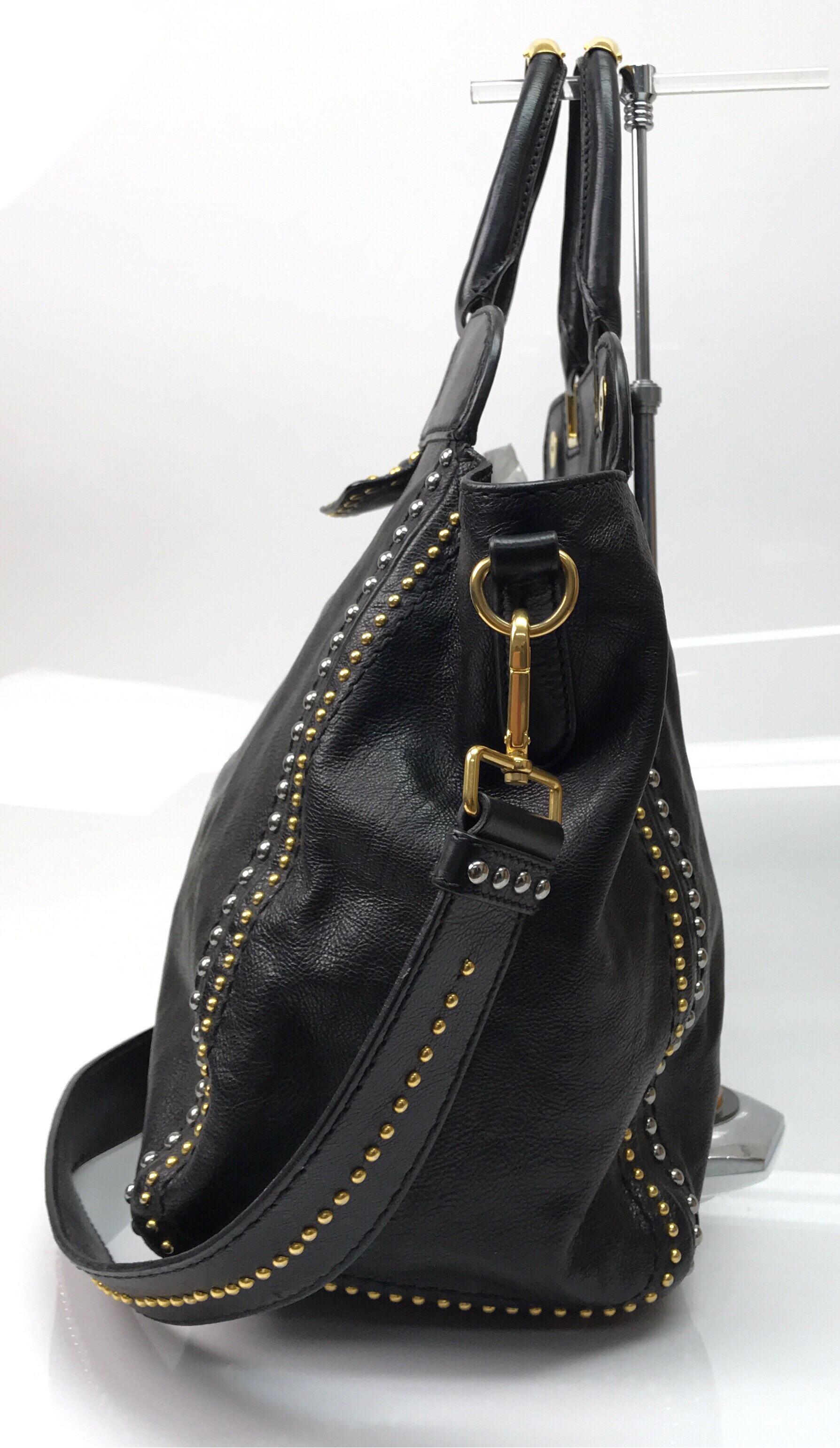 PRADA Runway Black w/ Gold&Silver Studded Large Tote. This amazing Prada tote is in great condition. It has minimal sign of use that is consistent with age. It is made of black leather with gold and silver studs throughout. There is a black leather