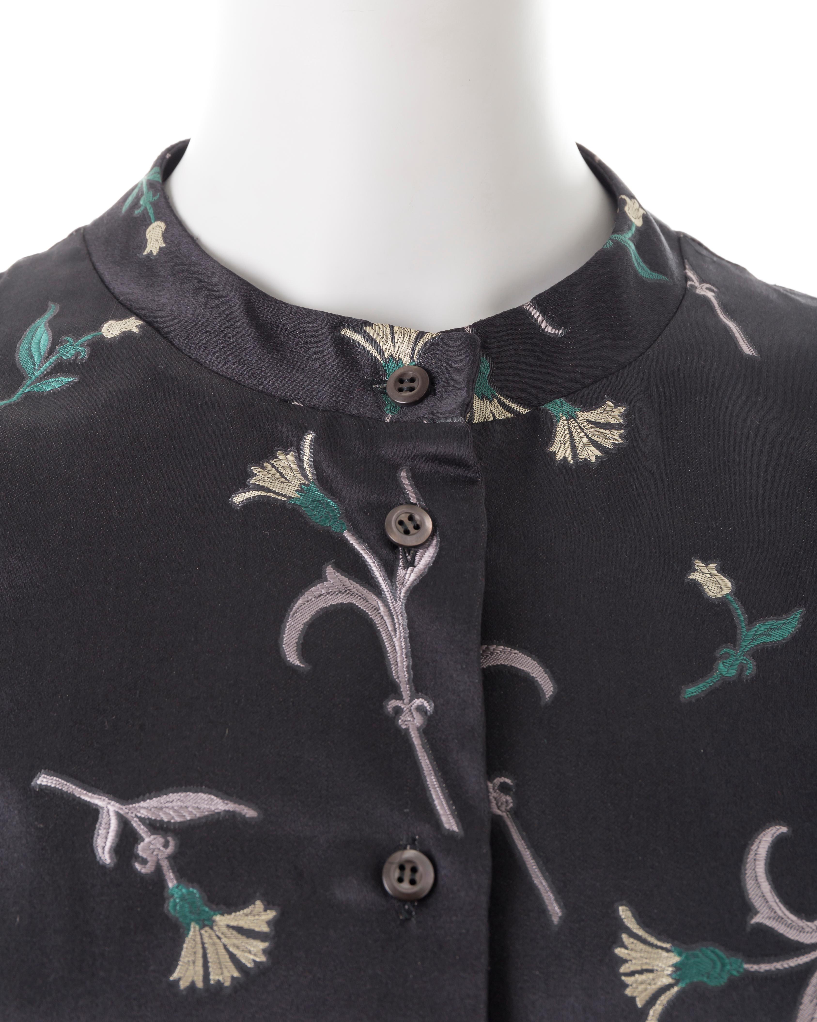 - Black silk button-up shirt
- Mandarin collar
- Long sleeves
- Floral jacquard print
- Size IT 44