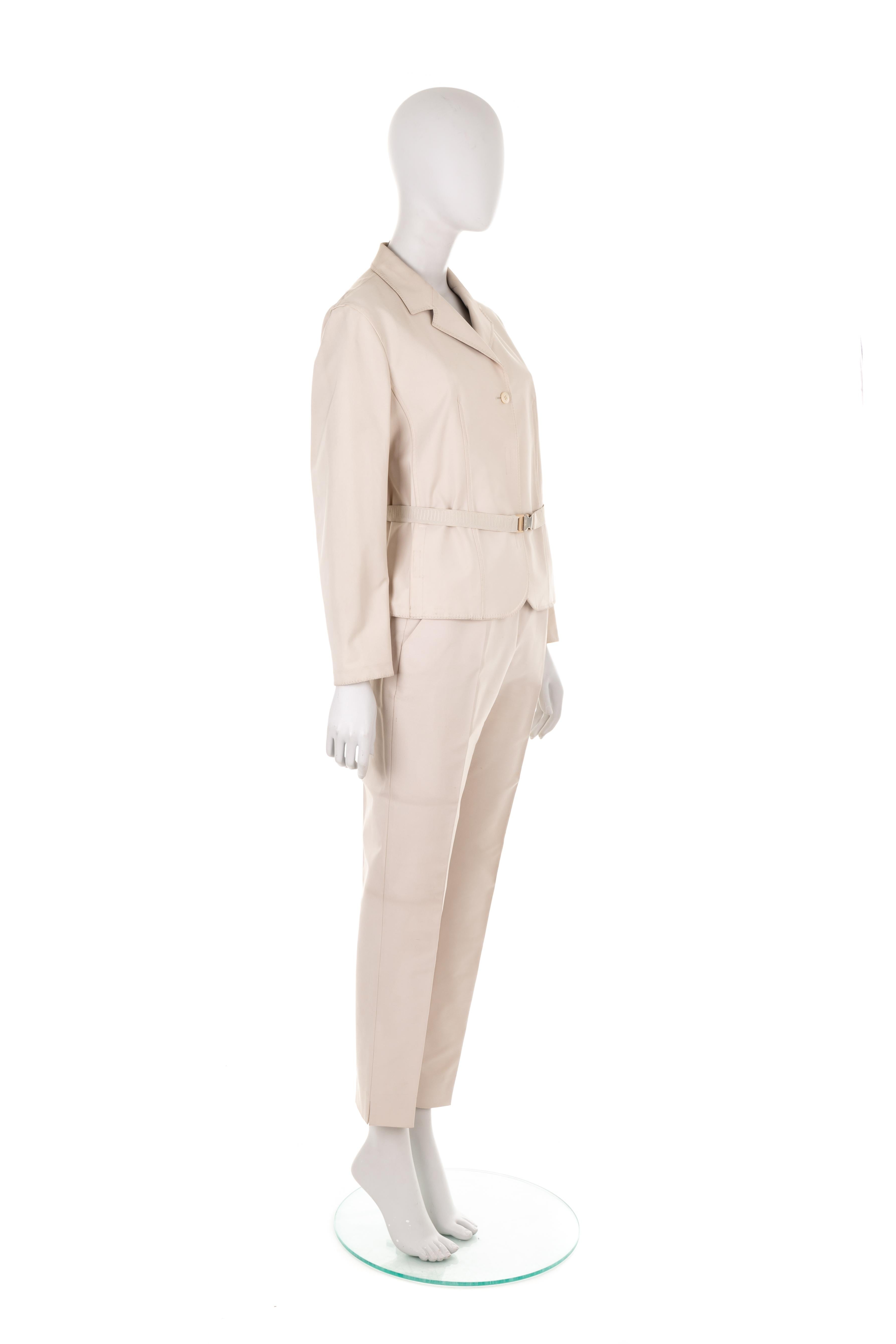 - Prada by Miuccia Prada
- Spring Summer 1998 collection
- Off-white nylon pant suit
- Structured blazer with velcro fastening
- Slim fit trousers
- Additional elastic waist-belt with logo buckle
- Size IT 44

JACKET
Shoulder to shoulder: 41 cm/