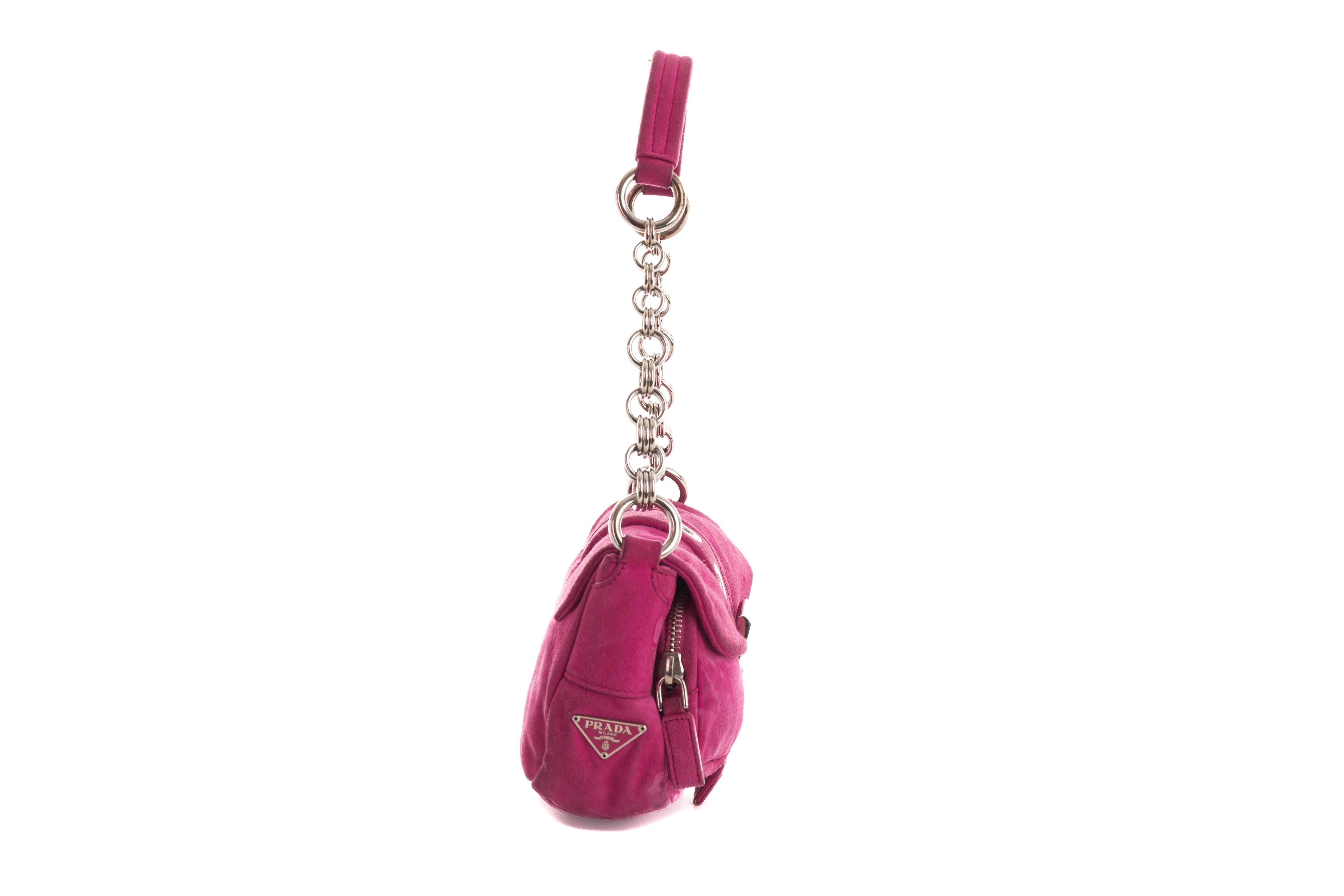 - Prada by Miuccia Prada
- Spring-summer 2004 collection
- Sold by Gold Palms Vintage
- Fuchsia suede mini bag
- Side pink logo
- Front double pocket and grommet belt
- Metal chain + suede strap
- Leather discoloration on the front (reflected on