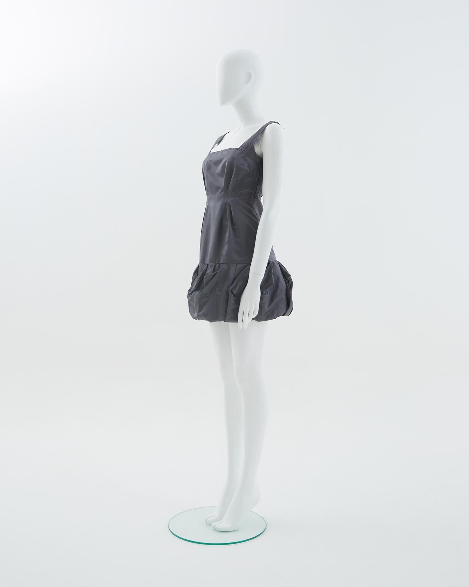 - Spring Summer 2007
- Sold by Skof.Archive
- Designed by Miuccia Prada
- Dark gray silk cocktail dress
- Sleveless
- Hidden side zipper closure 
- Ruffled detail on the bottom
- Made in Italy

Condition: Excellent Wear consistent with age and use.