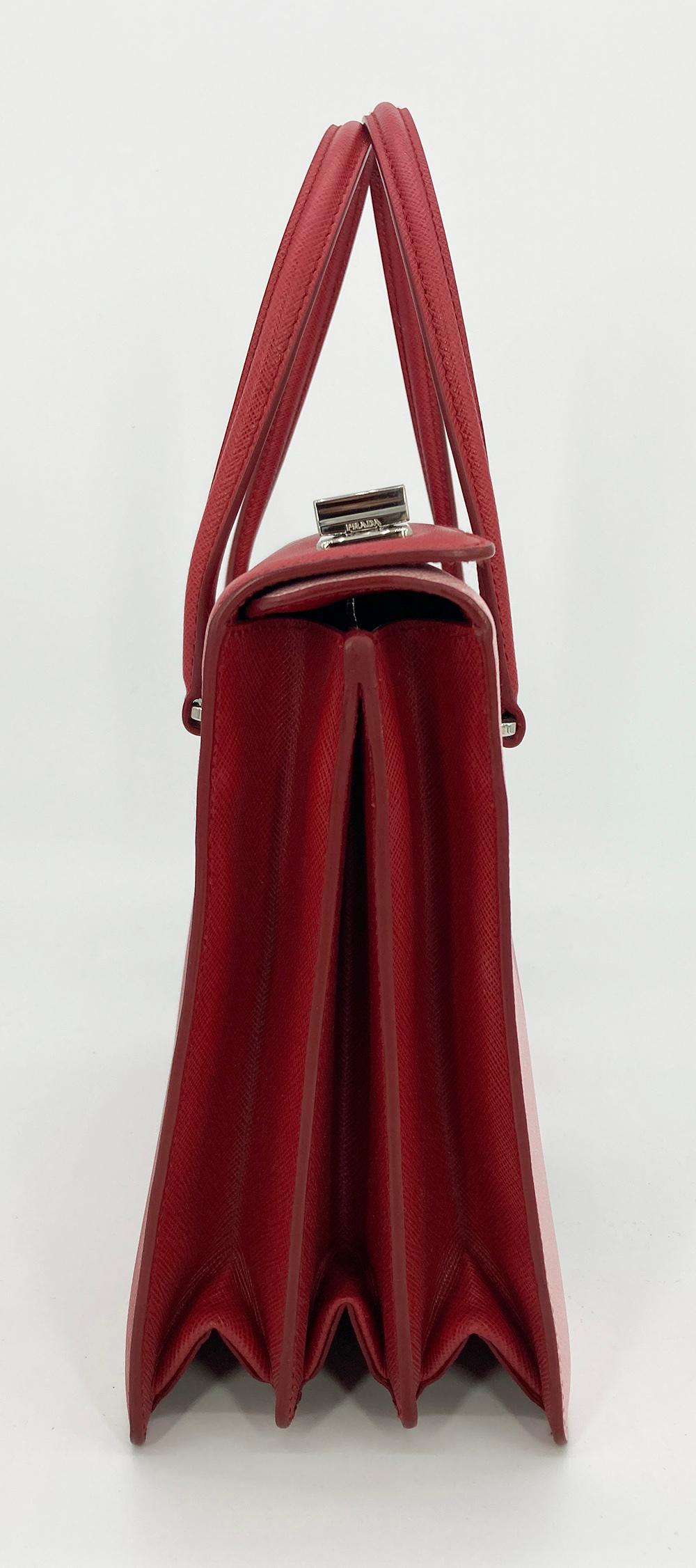 Prada Saffiano Face Art Bag in excellent condition. Alabaster and fuoco Saffiano leather with painted woman's face along front side. Double top handles and silver hardware trim. Top double twist locks open to a red leather interior with 2 separate