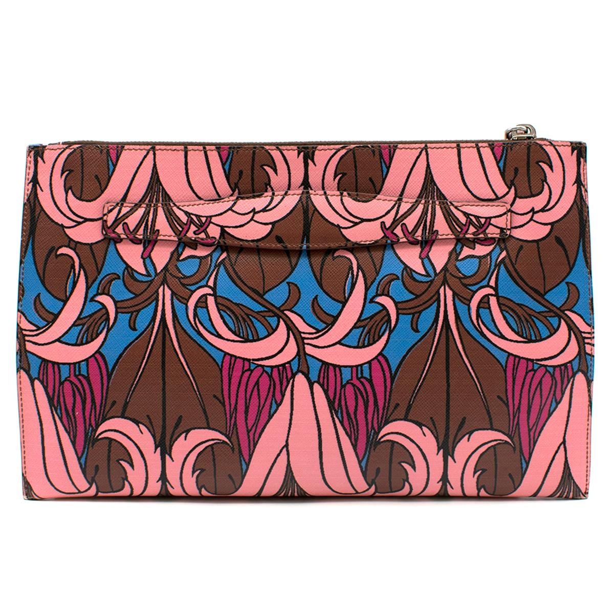 Prada Saffiano Floral Print Clutch

- Multi Colored Clutch Pochette
- Saffiano leather
- Brown, pink, blue floral print 
- Exterior: Zipped top opening with buckle closure, hand strap, silver tone hardware
- Interior:  Brown leather lining, zipped