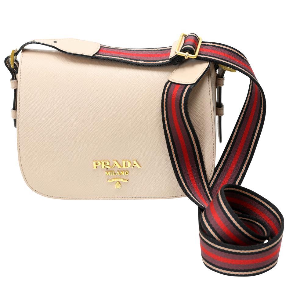 Luxurious Saffiano Prada cross body bag with beautiful wide web striped multi color shoulder strap. Beige finely textured leather with gold PRADA Milano logo and gold hardware. This versatile bag will take you from day to evening with effortless