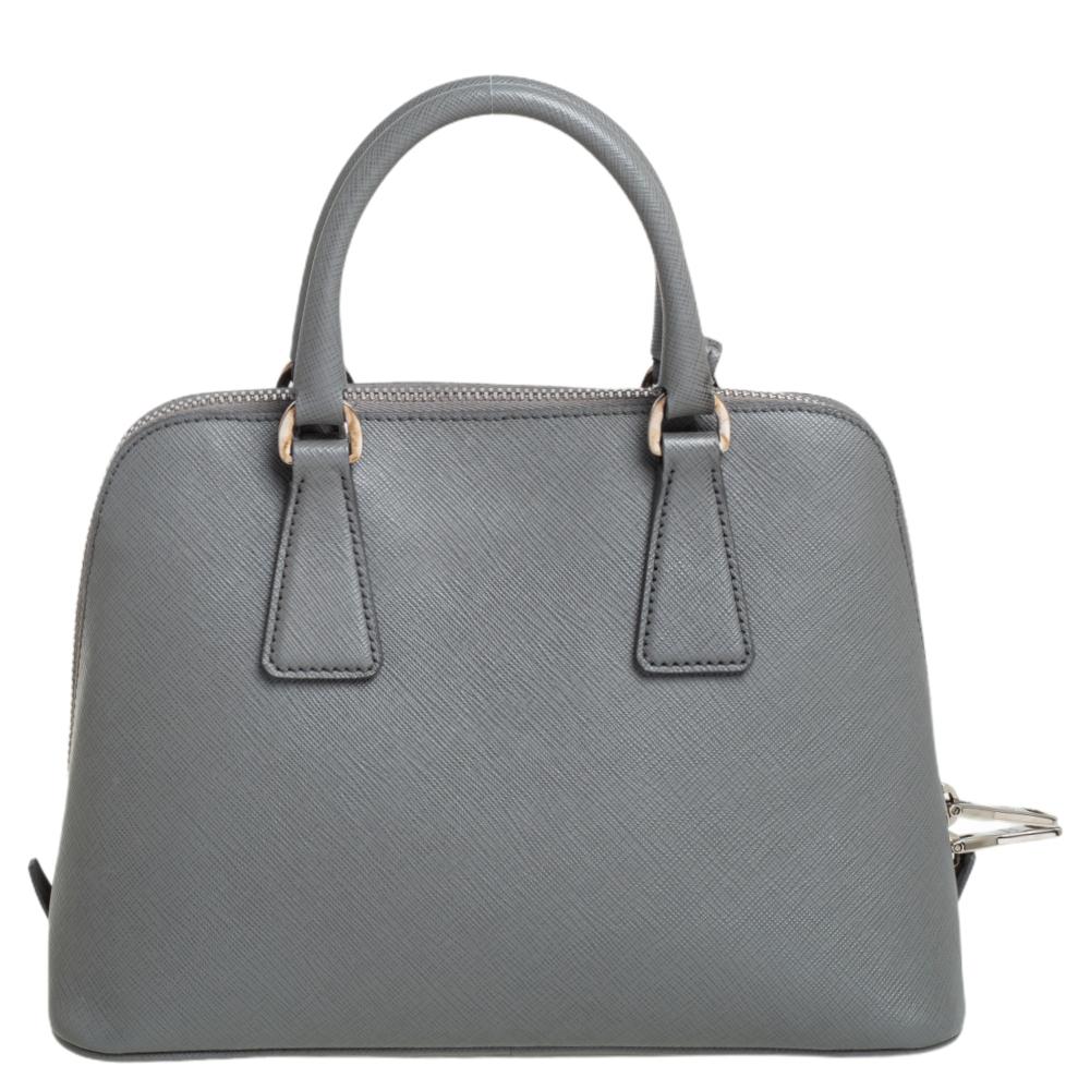 This stunning Promenade tote is high on appeal and style. Dazzling in a classy grey shade, the bag is crafted from Saffiano leather and features two rolled handles. The zip closure leads way to a nylon interior with enough space for your essentials