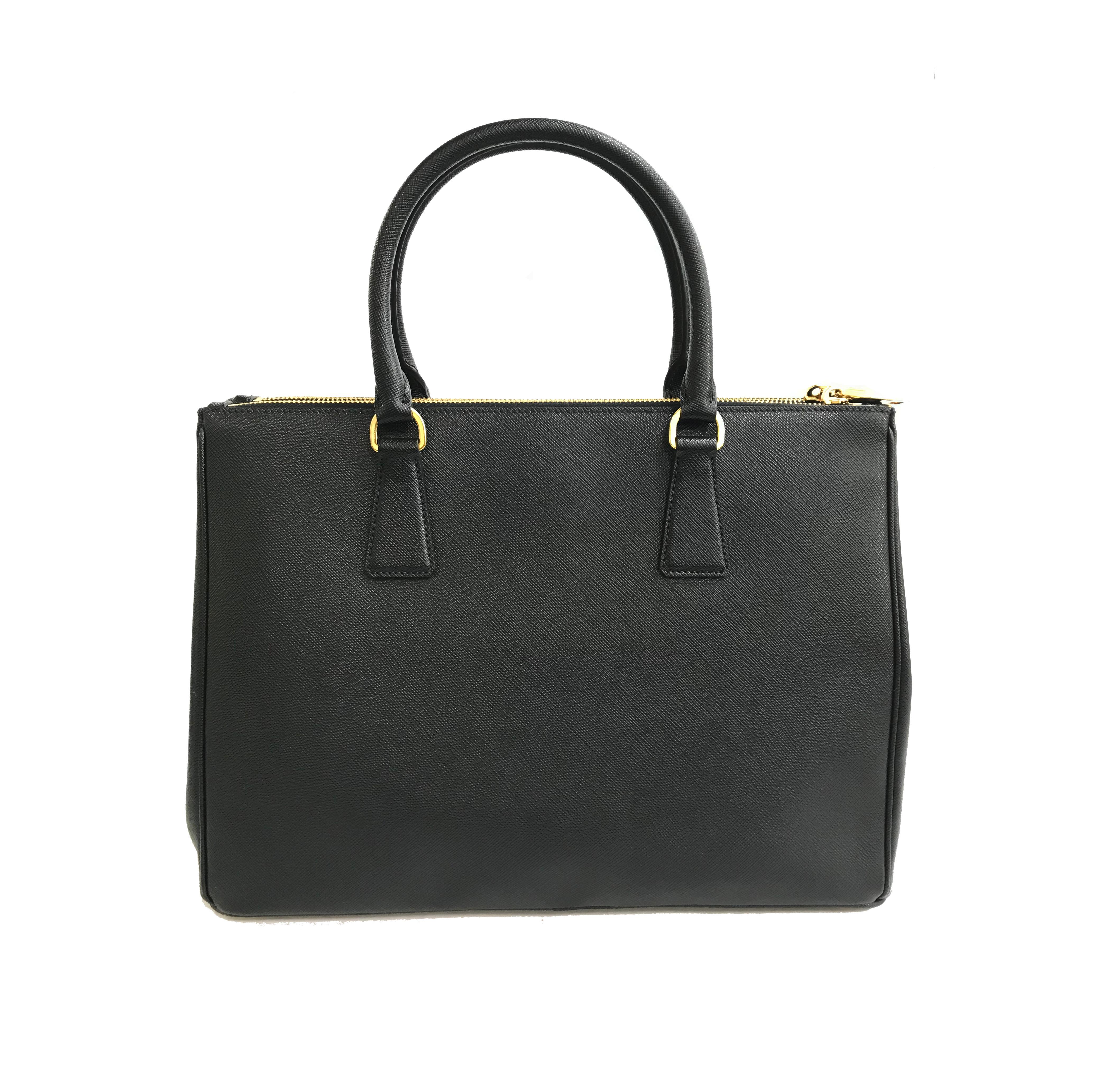 Prada's Galleria Saffiano tote is a perfectly prim addition to your accessories edit. Crafted from textured black calf leather, this design is finished with dainty top handles and golden hardware. Double storage compartments leave ample room for