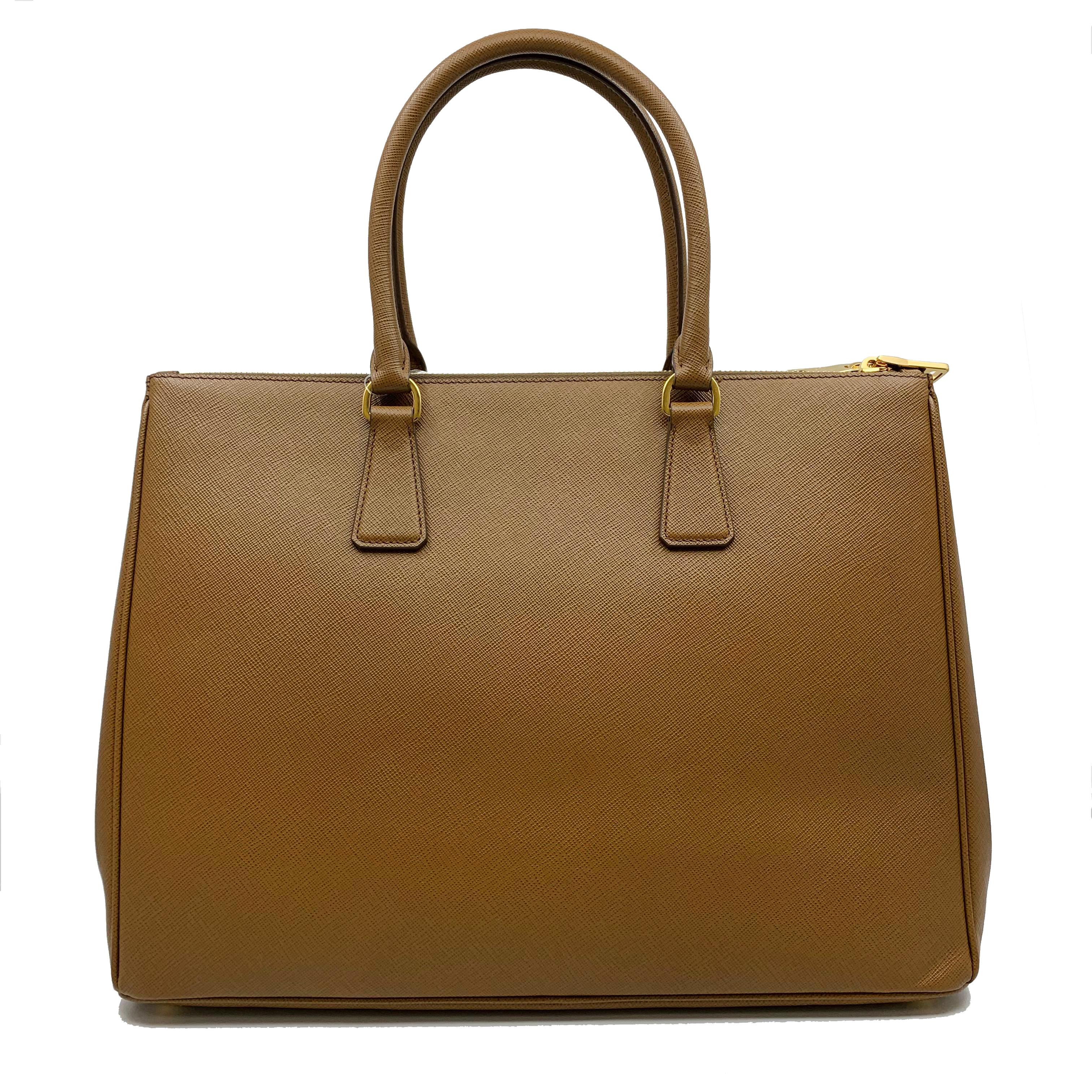 Prada's Galleria Saffiano tote is a perfectly prim addition to your accessories edit. Crafted from textured brown calf leather, this design is finished with dainty top handles and golden hardware. Double storage compartments leave ample room for