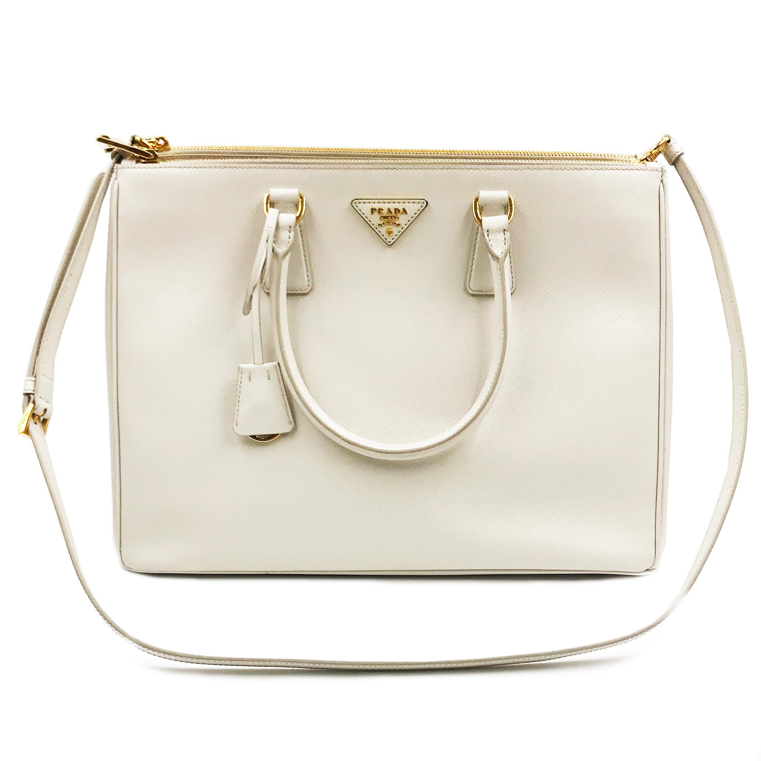 Prada's Galleria saffiano tote is a perfectly prim addition to your accessories edit. Crafted from textured white calf leather, this design is finished with dainty top handles and golden hardware. Double storage compartments leave ample room for