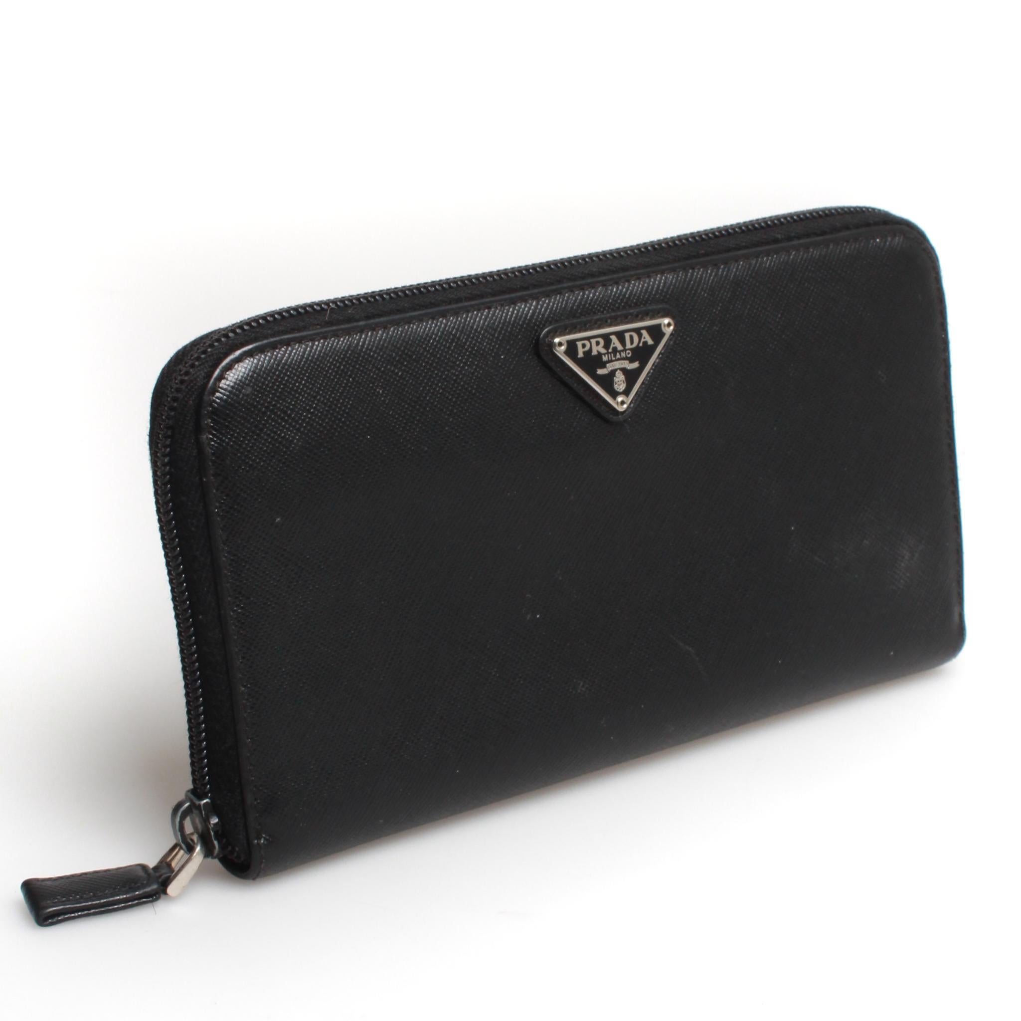 Classic PRADA saffiano leather zip travel wallet in black.

