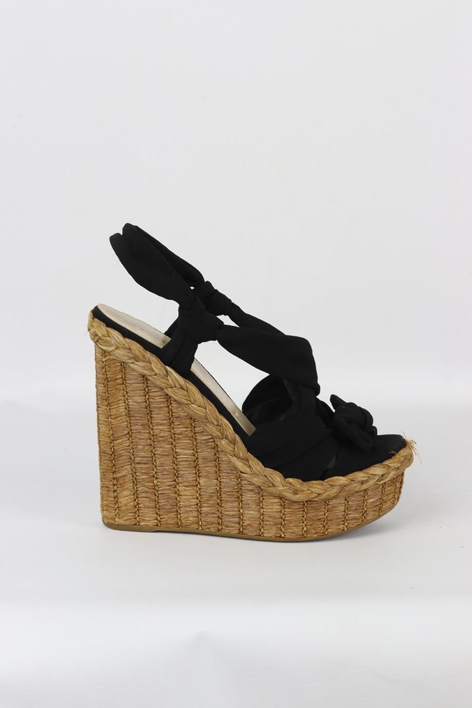 Prada satin and raffia espadrille wedge sandals. Black. Pull on. Does not come with dustbag or box. Size: EU 38 (UK 5, US 8). Insole: 9.5 in. Heel Height: 5.6 in. Platform: 1.6 in. Very good condition - Some wear to soles. Light wear to upper