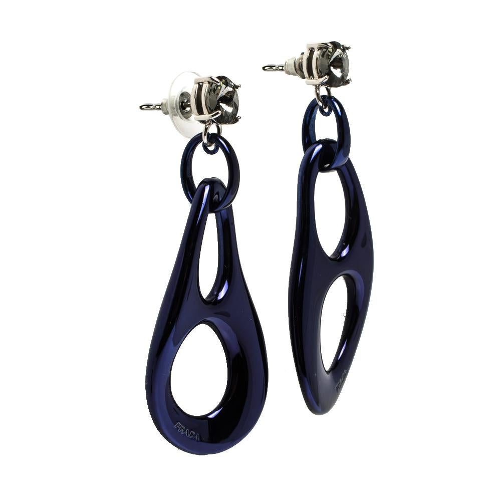 An ideal creation to elevate the charm of your evening looks, this pair of earrings from Prada is simply gorgeous. Shaped as drops with abstract cutouts, it is crafted in blue-tone metal and has a crystal stud. They feature a comfortable push-back