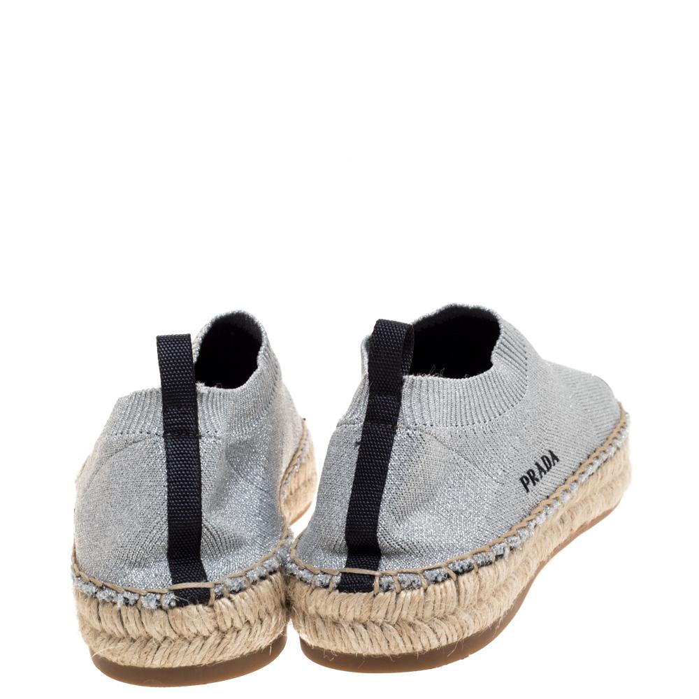 A stylish and luxurious daytime pair, these beautiful Prada espadrilles are easy to slip on over casuals. Constructed in shimmery silver knit fabric, this pair features durable soles, sock-like collars and contrast toes to complete the