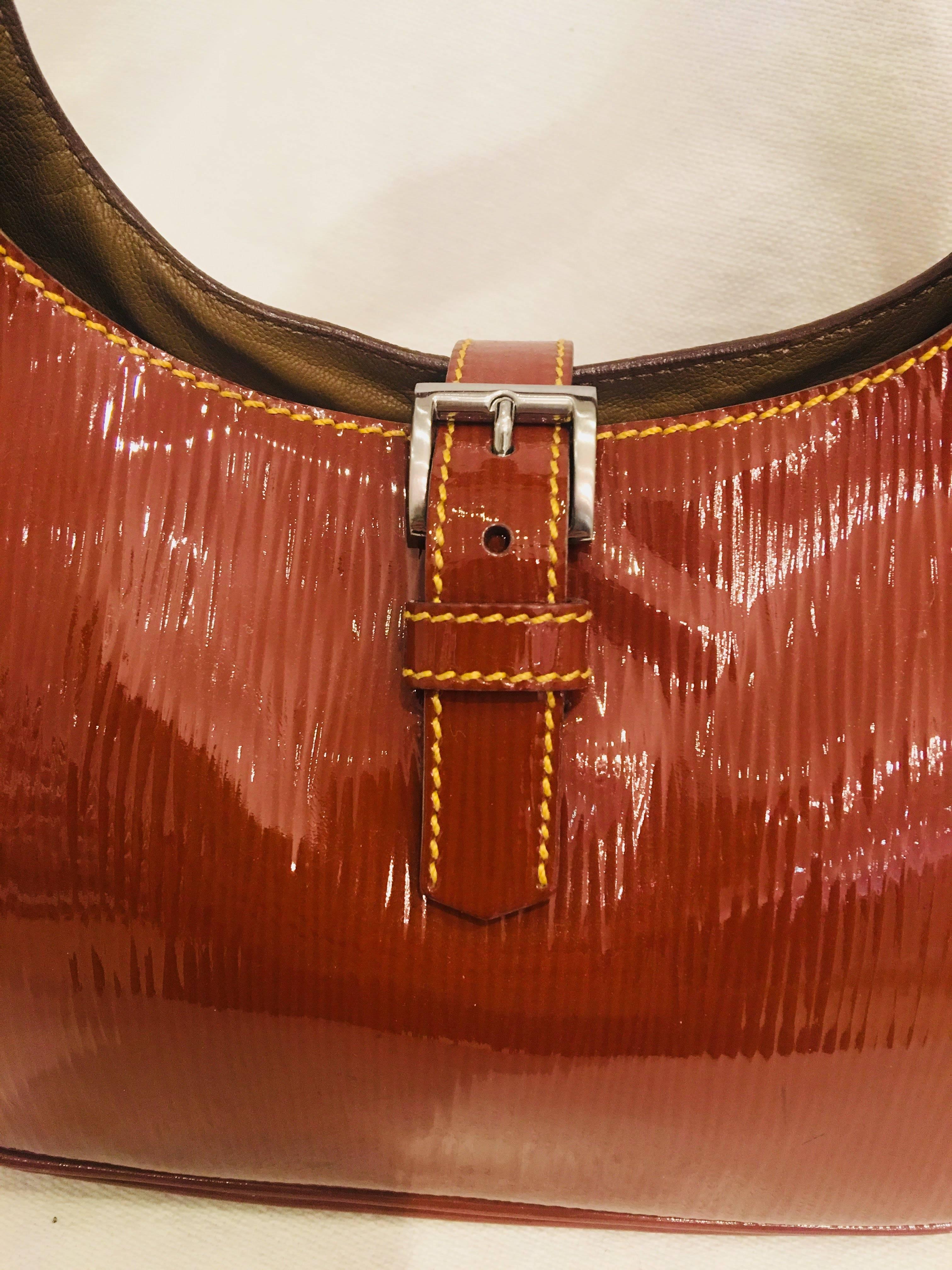 Prada Kidney Bean Single Strap Brown Patent Leather Shoulder Bag with Buckle Closure, Silver Hardware and Tan Stitching.