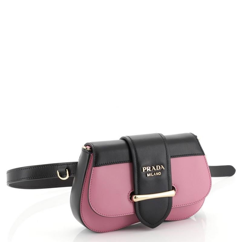 This Prada Sidonie Belt Bag City Calf, crafted from pink city calf leather, features a leather belt strap and gold-tone hardware. Its flap opens to a black leather interior with side slip pocket. 

Estimated Retail Price: $1,790
Condition: