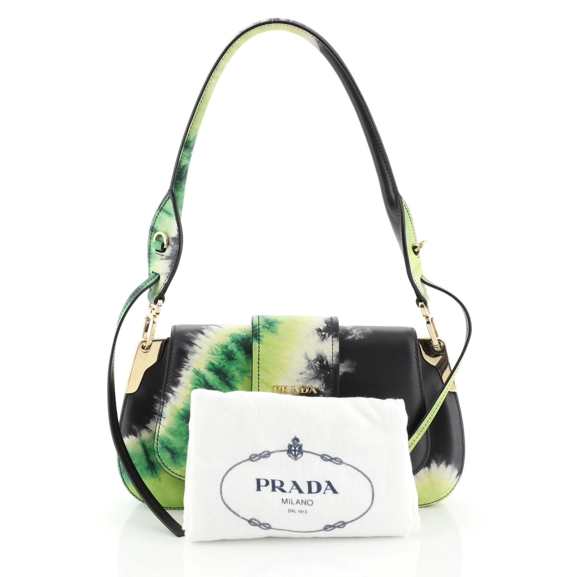 This Prada Sidonie Shoulder Bag Printed Leather Medium, crafted from green printed leather, features a rolled top handle and gold-tone hardware. Its flap opens to a black leather interior with side slip pocket. 

Estimated Retail Price:
