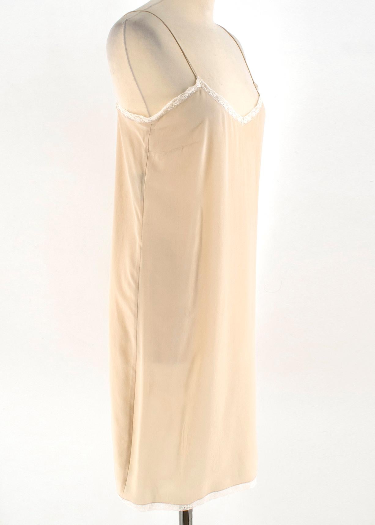 Prada Silk blend Nude Mini Slip Dress

- Nude mini slip dress
- Spaghetti straps
- V neckline
- Pull on and button fastening to the top side
- Lace trim

Please note, these items are pre-owned and may show some signs of storage, even when unworn and