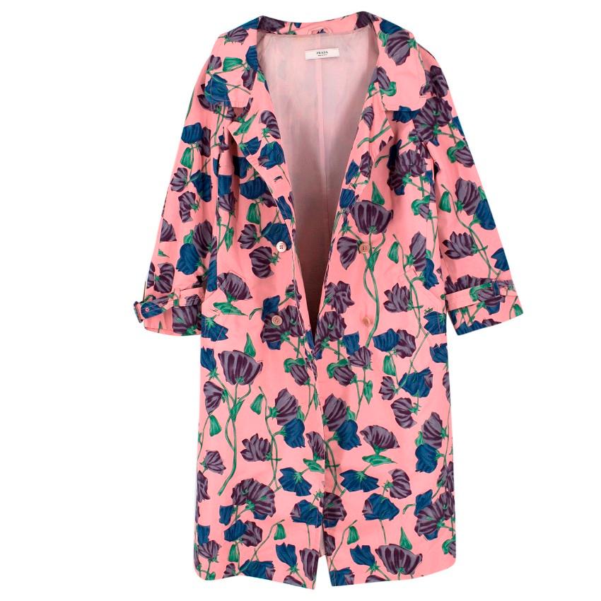 Prada Silk Floral Trench 

- Pink in colour with purple, blue and green illustrated floral print all-over
- 3/4 length sleeves with buckles to the cuffs
- Double breasted 
- Longline 

Please note, these items are pre-owned and may show some signs
