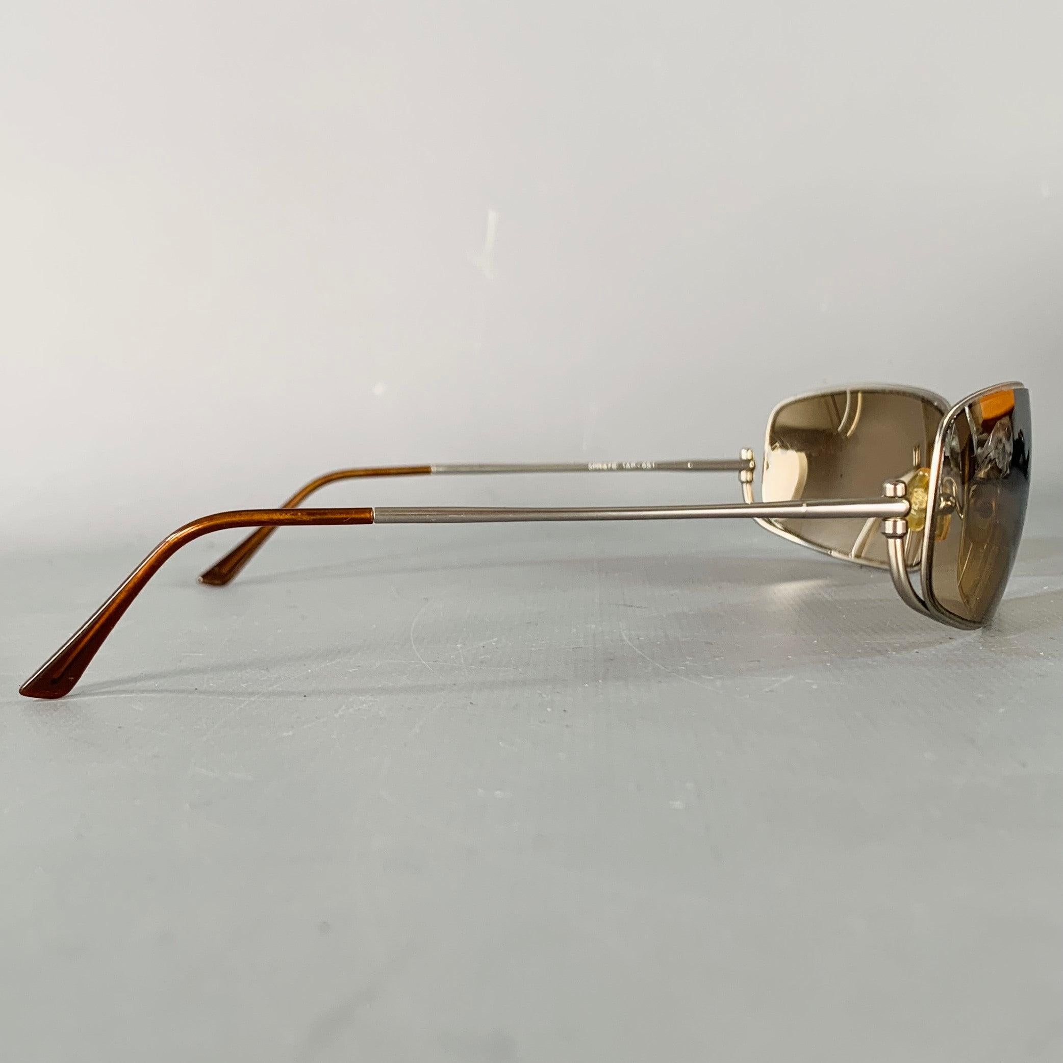 PRADA sunglasses
in a silver tone metal featuring a rectangle design with brown temple arm accents and mirrored lenses. Comes with case and box. Made in Italy.Very Good Pre-Owned Condition. Moderate signs of wear on hinge of case. 

Marked:   SPR57E