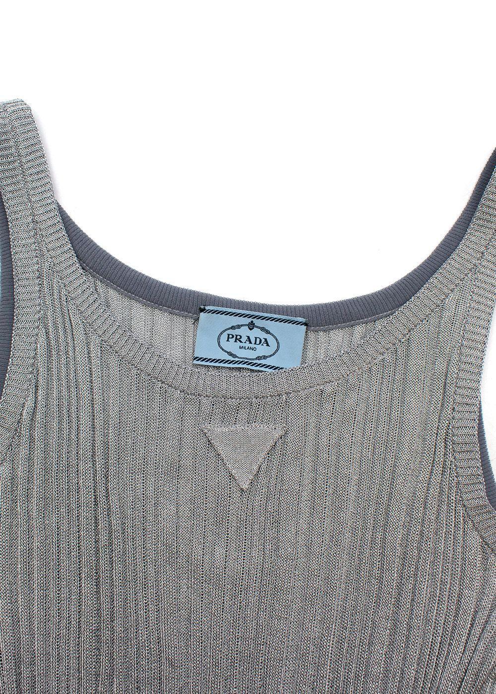 Prada silver lurex plisse knit tank dress

A precious motif formed by different types of ribbing creates a sunray pleat effect in this elegant, luminous dress. This lamé style embodies the technical know-how of the brand, which is capable of