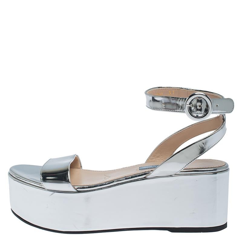 We can't stop admiring this amazing pair of sandals from Prada. They have been crafted from silver leather and styled with single front straps. The sandals also carry comfortable leather insoles, buckle strap fastening and 4.5 cm platforms.

