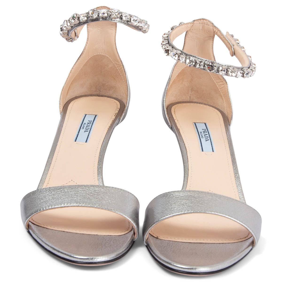 100% authentic Prada ankle-strap kitten heel sandals in silver calfskin embellished with clear crystals around the strap. Have been worn once and are in virtually new condition. 

Measurements
Imprinted Size	40
Shoe Size	40
Inside Sole	26.5cm