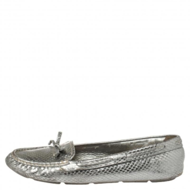 Loafers from Prada are always a favorite and these ones in silver are simply amazing! They have been crafted from python-embossed leather and styled with round toes and bow details on the vamps. They come endowed with comfortable insoles and rubber