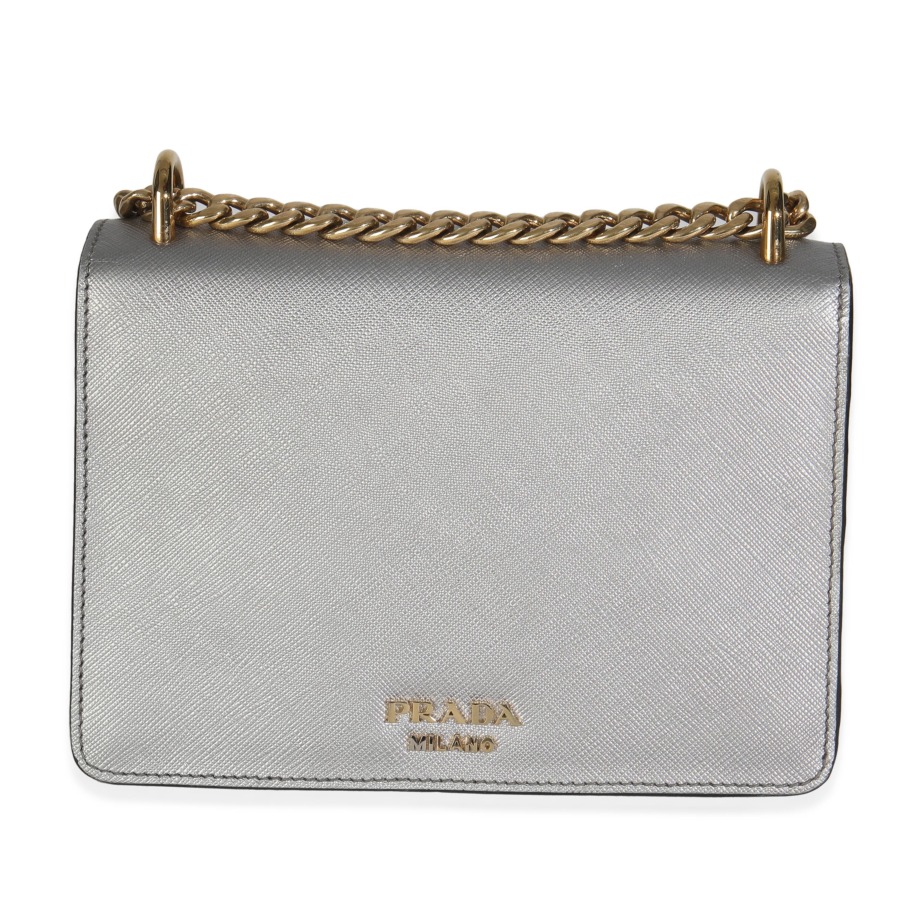 Listing Title: Prada Silver Saffiano Soft Calfskin Metal Triangle Logo Envelope Chain Bag
SKU: 147927
MSRP: 2600.00 USD
Condition: Pre-owned 
Handbag Condition: Very Good
Condition Comments: Item is in very good condition with minor signs of wear.