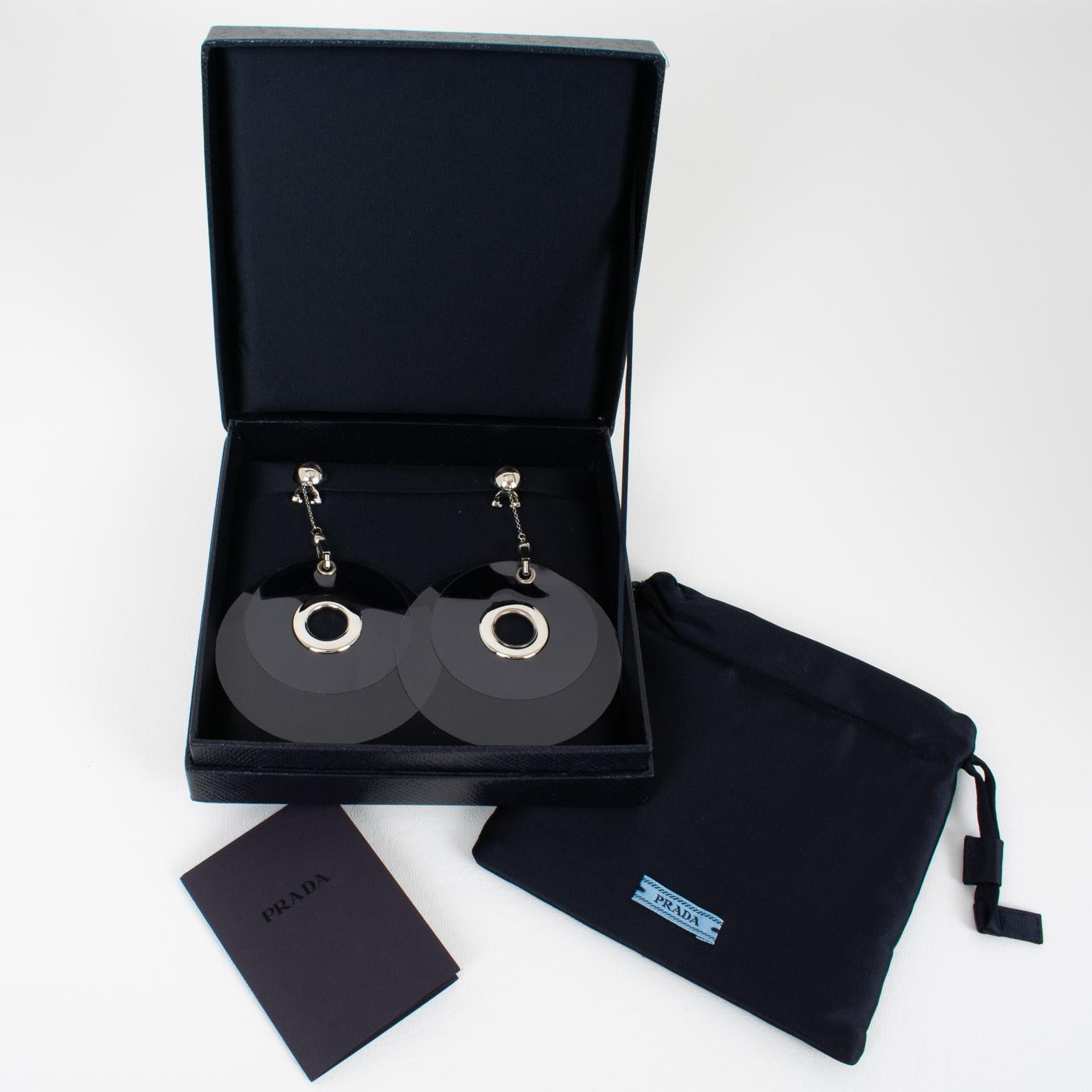 Prada, Italy, designed these spectacular dangling clip-on earrings for its 2016 runway spring-summer ready-to-wear show. These oversized, rare shoulder-duster earrings will make you shine no matter the occasion. They come from the house of Prada and