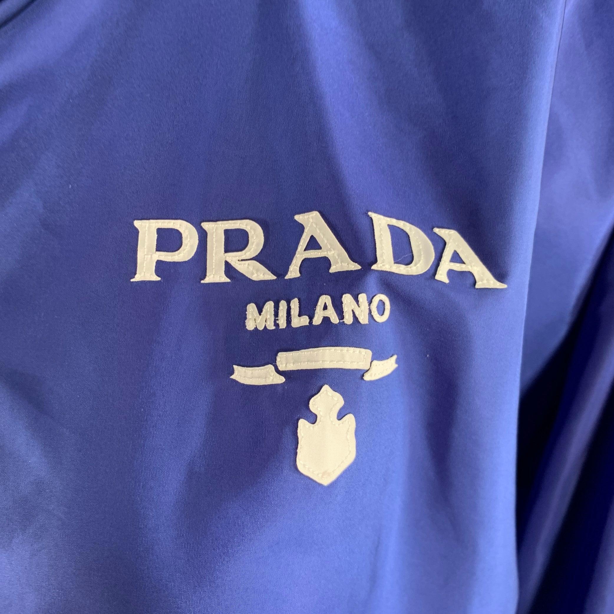 PRADA RE-NYLON jacket
in a blue polyamide featuring an oversized windbreaker style, hidden zip away hood, and zip up closure. Made in Romania.Excellent Pre-Owned Condition. 

Marked:   36 

Measurements: 
 
Shoulder: 17 inches Bust: 46 inches