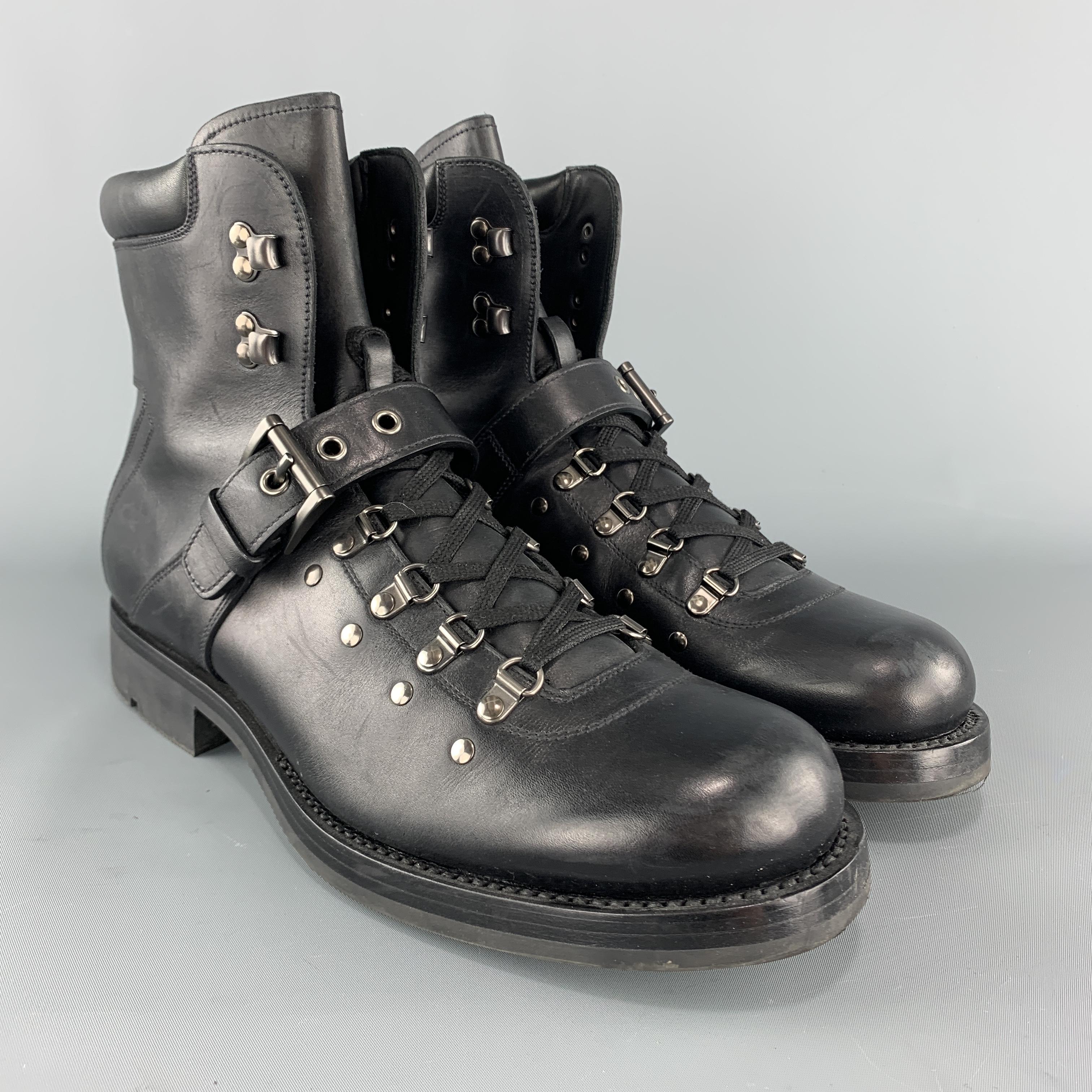 PRADA hiking boots come in black leather with ski hook grommet lace up front, buckled strap, and rubber sole. Made in Italy.

Excellent Pre-Owned Condition.
Marked: UK 9

Outsole: 12.5 x 4.5 in.
Length: 6 in.
Heel: 1.5 in.