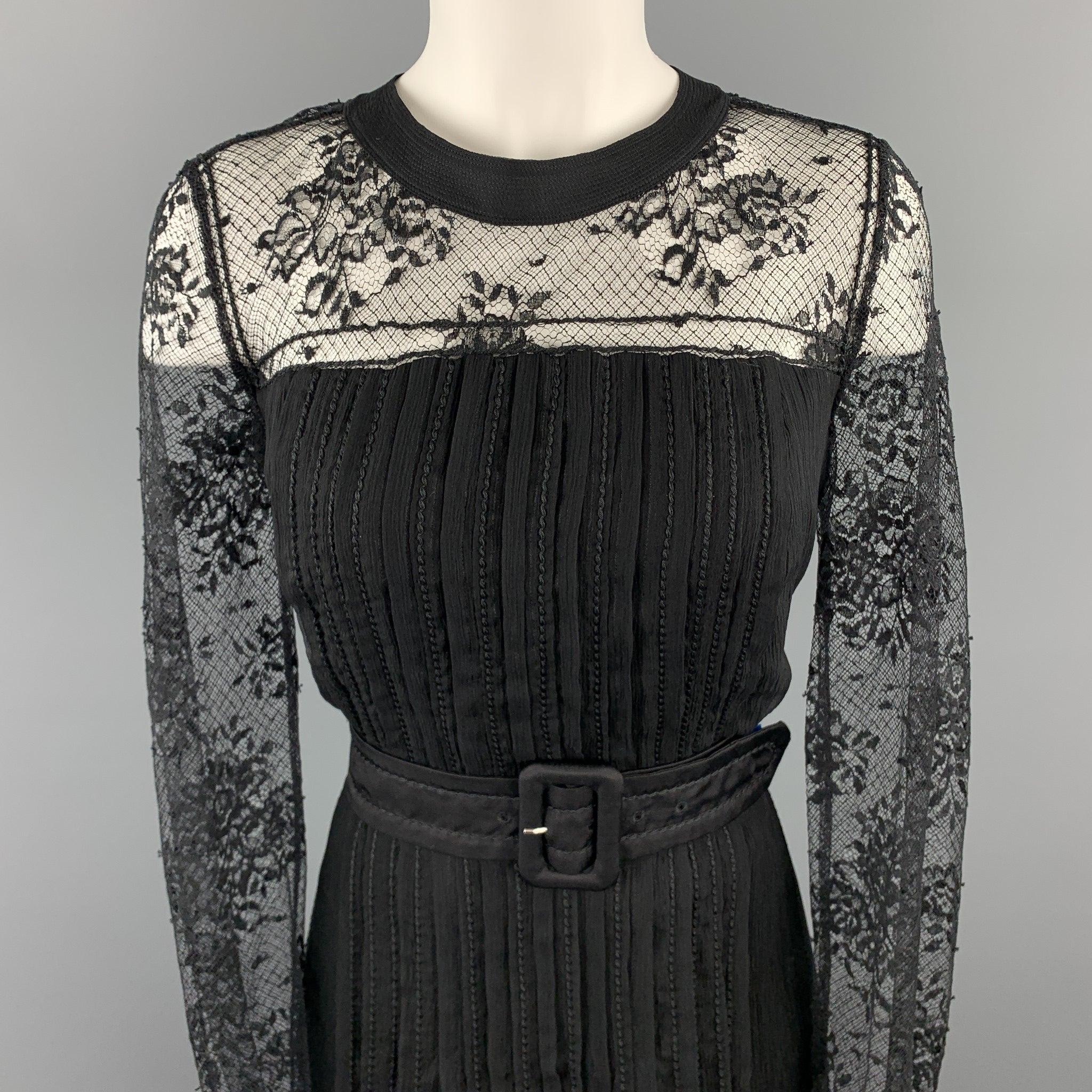 PRADA cocktail dress comes in black pleated silk crepe chiffon with top stitching throughout, belted waist, lace long sleeve top, and tied back neck. Made in Italy.Excellent
Pre-Owned Condition. 

Marked:  IT 46 

Measurements: 
 
Shoulder:
14
